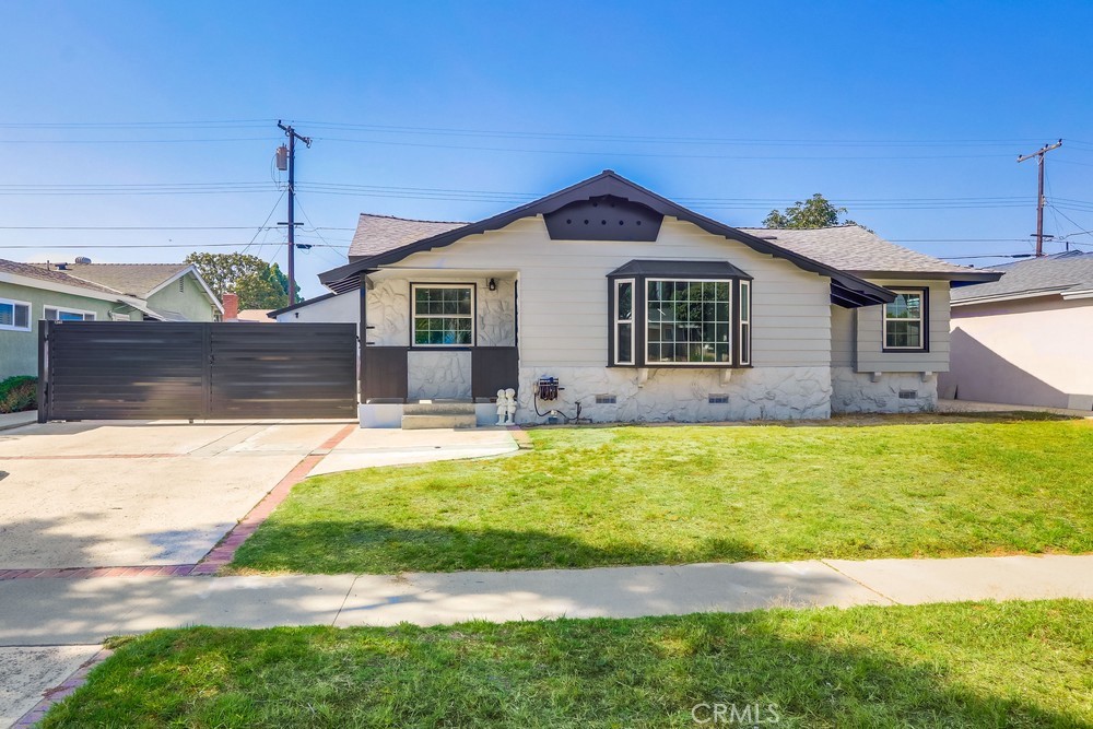 Sleek and stylish, this modern single-story pool home in a desirable Anaheim neighborhood blends timeless curb appeal with high-end upgrades. Inside, an open-concept layout features recessed lighting, large windows, and a chef-inspired kitchen with marble waterfall countertops, premium appliances, soft-close cabinetry, and bar seating. Smart, energy-efficient updates include Nest-controlled HVAC, tankless water heater, solar panels, and new plumbing throughout. The private primary suite offers a walk-in closet and spa-like en-suite bath. Two additional bedrooms share a beautifully updated hallway bath with designer finishes. A spacious bonus room with wood paneling, fireplace, and outdoor access offers versatile space for a gym, studio, or lounge. Step outside to a private, fully paved yard with a sparkling pool—perfect for entertaining or relaxing in the sun. Ideally located near the Anaheim Packing District, Disneyland, and Angels Stadium.