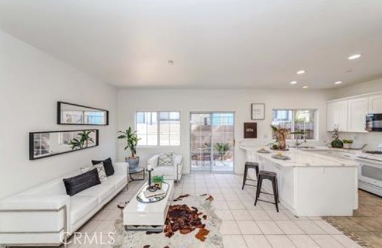 GATED 3 BEDROOM AND 2.5 BATHROOM TOWNHOME IN GREAT CONDITION WITH ATTACHED 2 CAR GARAGE. QUARTZ COUNTER TOP, TILE, LAMINATED WOODFLOOR, BLINDS, CEILING FAN, FIREPLACE IN LIVING ROOM AND PATIO. SPACIOUS MASTER BEDROOM WITH WALK IN CLOSET AND BALCONY. INSIDE LAUNDRY ROOM IN UPSTAIRS. CONVENIENTLY LOCATED NEAR MAJOR FWY 5 & 91, NEARBY SHOPS, RESTAURANT AND SO MUCH MORE TO ENJOY. WATER AND TRASH INCLUDED.