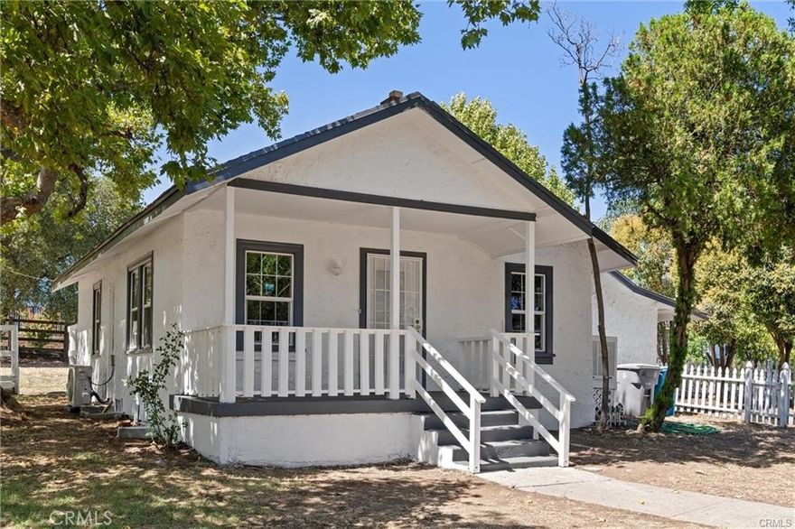 This adorable 3-bedroom, 2-bath home is has so much to offer!   This home features new laminate flooring in the living room & kitchen, sleek countertops, a new mini split, as well as a fireplace, and a dedicated indoor laundry room for added convenience. There is a large attic accessible from inside the home with potential for an amazing loft. Outside, the charming picket fence is sure to catch your eye, on this fully fenced and spacious quarter-acre lot, providing plenty of room for a shop or gardening. The street behind the home allows for easy access when parking your big toys. Enjoy being just moments away from local amenities, schools, the Oroville Dam, and nearby trails at this delightful home!