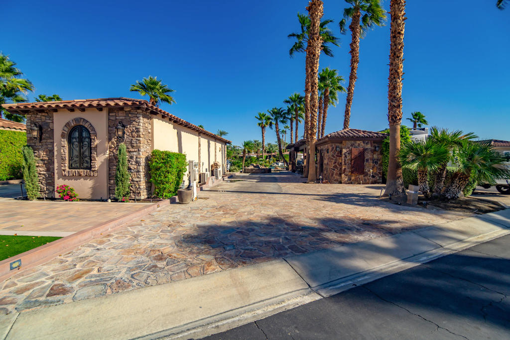 Lot 230 captures some of the most spectacular views in Motorcoach Country Club, offering sweeping 180 panoramas of the water, golf course, and surrounding mountains. The lot features a 9' x 13' casita with a comfortable guest bed and a 3/4 bathroom with a full tile shower, providing a cozy and functional space for guests or quiet retreat.Outdoors, a large wood pergola anchors the entertaining area, complete with an outdoor kitchen and built-in BBQ. The expansive patio offers multiple spaces for lounging and dining, all positioned to take full advantage of the stunning views. The pool and spa overlook the lake, creating the perfect setting to relax and enjoy the desert sunsets that make this property so special.With great bones and an unbeatable location, Lot 230 is waiting for your personal touch. Whether you choose to enjoy it as-is or reimagine it into a modern showpiece, the potential is undeniable. Unique Islands has already completed a remodel design concept that retains the existing pool while updating the layout with a fresh, luxury aesthetic--offering a clear vision of what's possible for this prime waterfront lot.Motorcoach Country Club offers resort-style amenities including a private golf course, three pools and spas, pickleball and tennis courts, a fitness center, and a fully renovated clubhouse with restaurant and bar. Scenic waterways invite boating and paddleboarding, and a full calendar of social events brings the community to life.Photos captured during the annual turf renovation in October -- the course is already greening up beautifully and will be lush and vibrant within weeks. Stay tuned for updated photos!*Motorcoach Country Club exclusively accommodates Class A motorhomes from 30' to 45'. Due to zoning, on-site properties are not considered dwellings, and overnight stays inside them are not allowed. MCC's annual Food & Beverage minimum is $2,080.