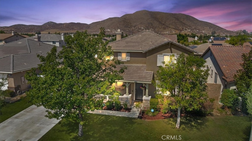 Welcome to your dream home in the highly desirable Heritage Lake community, just 150 yards from the lake via a beautifully landscaped walking path! This spacious and well-maintained home offers the perfect blend of location, comfort, and lifestyle amenities. With 3,020 sq ft of living space on a generous 8,276 sq ft lot, the home features 4 sizable bedrooms, 3 bathrooms, and a 3-car garage—ideal for growing families or those needing extra space. The interior showcases a thoughtfully designed floor plan with new plank flooring throughout the downstairs and custom interior paint, creating a fresh and inviting atmosphere. The main floor full bathroom adds flexibility and convenience for guests or multi-generational living. At the heart of the home, the kitchen boasts granite countertops, a center island, and stainless steel appliances, and it opens seamlessly to a large family room highlighted by a beautiful stacked stone fireplace—creating a warm, comfortable space for everyday living and entertaining. Step outside to your private backyard retreat featuring lush green landscaping, new fencing, a full-length covered patio with ceiling fan, extensive hardscape, and a cozy firepit—an ideal setting for outdoor relaxation and gatherings in the evenings. The 3-car garage includes built-in storage racks, adding extra functionality and organization. A welcoming front porch enhances the home’s curb appeal and provides a charming entry. Heritage Lake is a vibrant master-planned community designed for connection, recreation, and convenience. Residents enjoy access to an abundance of amenities, including a private lake, scenic walking trails, swimming pool, children’s water park, sports courts, a welcoming clubhouse, and more. Nearby, you’ll also find tennis and pickleball courts for additional recreation. The home is within walking distance to local schools and offers quick access to the lake—just 150 yards from the front door to the lakefront area—through a beautifully maintained path at the end of the cul-de-sac. As an added bonus, the seller is offering $7,000 toward buyer’s closing costs or an interest rate buy-down, making this an outstanding opportunity to own a move-in ready home in one of Menifee’s most desirable neighborhoods. Don’t miss your chance to enjoy the best of Heritage Lake living in this beautiful home!