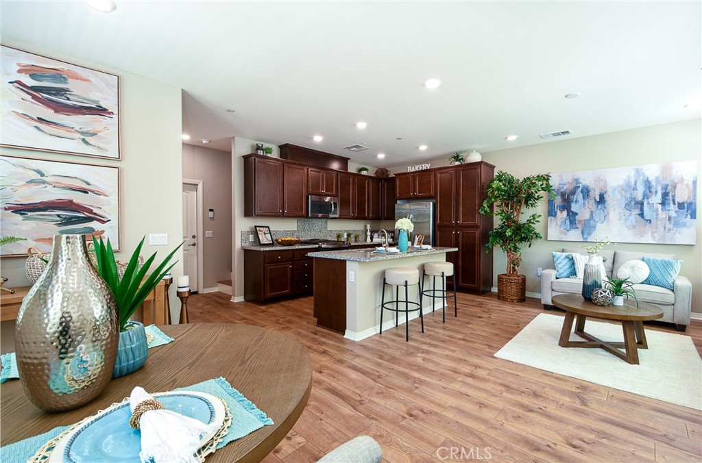 Welcome to Arroyo Vista, a resort style community in the heart of Murrieta! This is one of the most sought-after floor plans in the community. With over 1500 sq ft of luxury living space this home features 3 bedrooms 2.5 bathrooms and a 2 car attached garage. This beautiful home is an end unit located in a quiet part of the community and has an extra-large front patio that only a couple of homes have! Its a great place to BBQ and entertain friends and family! This home features luxury designer vinyl wood plank floors throughout the first floor, it carries up the staircase and into the spacious loft area upstairs. Upgraded carpet in the bedrooms. Large laundry room on the second floor for convenience. The gourmet kitchen features granite counter tops with an eat at island, SS appliance package and gorgeous espresso cabinets. Only one common wall makes this home feel like a single-family home! The community is like living at a resort with the sparkling pool and spa, tot lots and BBQ areas. See why so many people are flocking to this community.