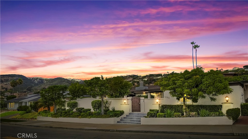 Coastal Elegance Meets Modern Luxury in Monarch Bay Terrace Perched within the prestigious enclave of Monarch Bay Terrace, this exquisitely reimagined single-level ranch-style estate captures the essence of decadence, sophistication, and premier coastal living along one of Orange County’s most celebrated coastlines. Set on nearly 15,000 sq. ft. of private grounds, this residence offers 6 bedrooms, 5.5 bathrooms, and 3,789 sq. ft. of masterfully designed living space. Four bedrooms feature en-suite baths, including a private guest suite with kitchenette—ideal for extended stays or multigenerational living. The interiors are marked by timeless design, refined finishes, and an effortless flow that invites light and ocean breezes into every corner. The spacious living areas and open-concept kitchen create a perfect backdrop for both casual family living and sophisticated entertaining. Seamless indoor/outdoor living defines the home, with expansive patios designed for both grand gatherings and quiet moments of retreat. The wraparound yard and private courtyard provide multiple spaces to relax, dine, and enjoy the coastal climate year-round. Just a 10-minute stroll to the sand, or a quick drive to the Ritz-Carlton, Monarch Beach Resort, world-class golf courses, and the vibrant Lantern District, the location is second to none. Here, every day feels like a luxury escape. With the Dana Point Harbor revitalization underway, this residence offers not only timeless elegance but also extraordinary investment potential in one of Southern California’s fastest-rising coastal markets. Step into the serene backyard retreat and you’ll understand why the owner describes life here as “a summer breeze that makes you feel fine.” This home is more than a residence—it is a statement of coastal sophistication, style, and the very best of California living.