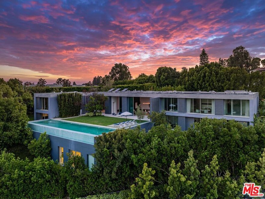 Exceptional Contemporary Estate Ideally located in the highly coveted lower Bel-Air at the end of the cul-de-sac! This architectural masterpiece by Marmol Radziner and Felicity Bell epitomizes modern luxury and European sophistication. Spanning over 14,000 square feet and offers unparalleled privacy and grandeur. This ultimate estate greets you with a spacious motor court and lush landscaping. Entry opens to a sky-lit gallery, leading into an expansive floor plan featuring dramatic 24-foot ceilings and a seamless flow of natural light. Floor-to-ceiling Fleetwood glass doors create a harmonious connection between the interior and the breathtaking outdoor spaces.  The formal living areas include a dual fireplace that divides the living and dining rooms, both designed for showcasing art collections. Each of the seven-bedroom suites boasts glass walls and spa-inspired bathrooms, offering serene views of the Bel-Air Country Club and the surrounding canyons. Luxury amenities include an indoor lap pool and wellness center, a state-of-the-art chef's kitchen, a dedicated art studio, and formal staff quarters. The estate's outdoor spaces are equally impressive, featuring a sprawling lawn, an infinity-edge pool, and a cabana/sunbathing deck. The entire structure is made entirely out of concrete! This estate is a testament to meticulous craftsmanship, extraordinary quality and a high level of sophistication, making it a rare opportunity for those seeking an unparalleled living experience in Los Angeles.