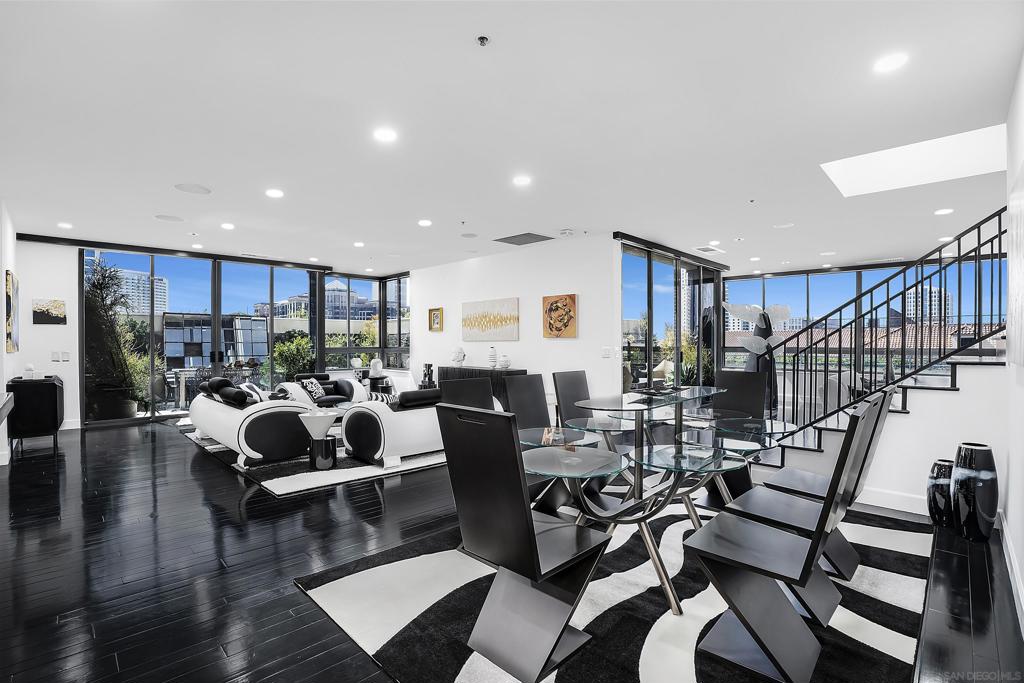 This exceptionally distinctive townhome-style unit, situated at the southwest corner of the 4th and 5th floors, offers expansive interior spaces that create a living experience akin to that of a traditional home. The four generous outdoor patios provide a tranquil retreat. Featuring a striking color palette, this residence showcases sleek contemporary decor while residing in a building that exemplifies five-star service and unparalleled distinction, a rarity in today's market. Enhanced with refinished hardwood flooring, brand new California closet systems, premium motorized window treatments, high-end appliances, recessed lighting, in-unit laundry, an electric fireplace, and numerous additional features, this home is truly remarkable. The building boasts a full array of amenities, including valet parking, security concierge, and an impressive outdoor plaza level complete with a pool, spa, firepit, health club, barbecue area, and a park-like environment that softens the surrounding urban landscape. Meeting rooms, lounges, and Guest suites are available for visitors and are managed by the building staff. The Meridian stands as San Diego's sole building that genuinely embodies 5-star luxury. Once experienced, the distinction is unmistakable.