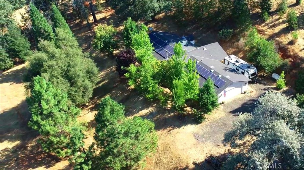 2 Homes on 6 + acres in the Pines, close to Yosemite. Main Home is 2006 large Western Home with 1,906 sq. ft., 2 bedrooms, an office, 3 bathrooms, inside laundry room, an attached garage, owned solar & a backup generator. Home is wonderfully shaded by a Big Leaf Maple & Sycamore trees. Beautiful custom kitchen features black Quartz countertops with matching appliances, custom pot rack, tile flooring, pantry, & propane cookstove. Nice open floorplan with gorgeous hardwood & tile floors. Master bedroom has 2 large walk in closets, 2 bathrooms with tile floors (one Full & one 3/4), & exterior access via French doors; Full bath has large jacuzzi tub & a step in shower. 3/4 bath has a pedestal sink & freestanding clawfoot tub. Additional Dwelling Unit is a 2002 Fleetwood manufactured home on permanent foundation; 960 sq. ft., 3 beds & 2 baths. In addition to all this, there is a 400 sq. ft. Storage/ Shop. For animal lovers, there is a fenced pasture for equines as well as an elaborate cattery built around the exterior of the home in the back & side yard.