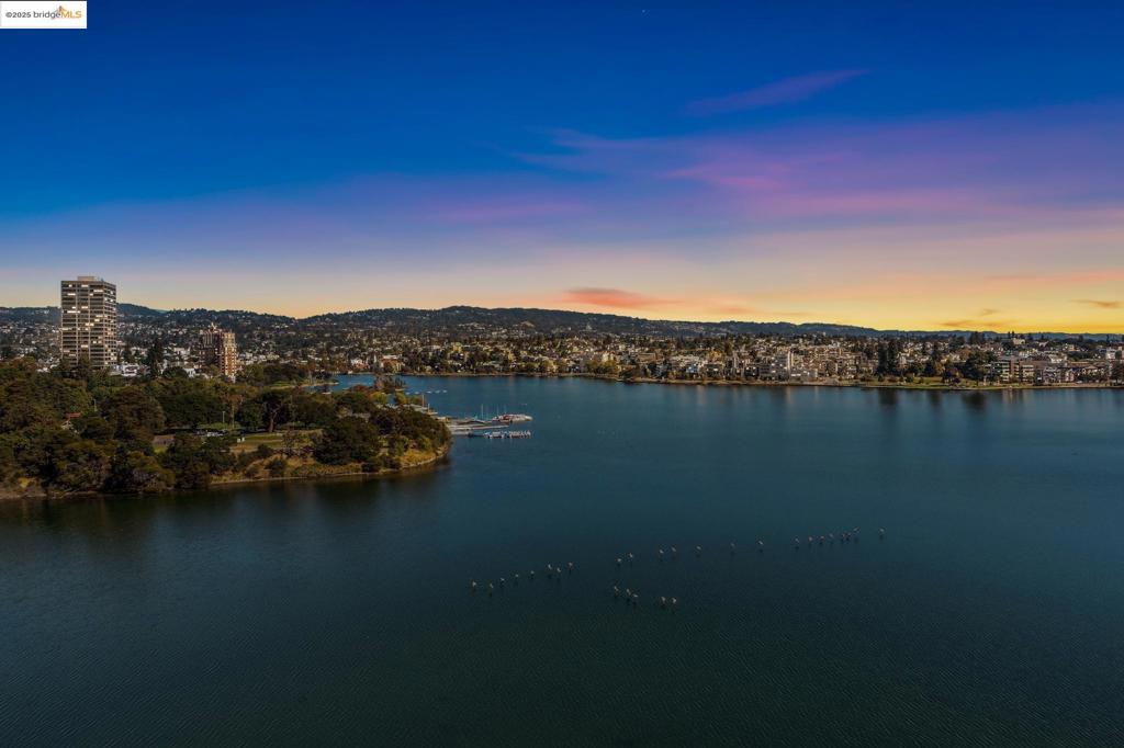 Welcome to this stunning 10th floor luxury unit that offers magical views of Lake Merritt, surrounded by a 122 acre park. This vibrant community hosts a variety of activities, including yoga classes, (including silent disco yoga), salsa dancing, lawn bowling, jogging trails, and paddle boating. This exceptional residence features 2 spacious bedrooms,2 elegant bathrooms along with the raity of 2 parking spaces. The open floor plan creates seemless flow throughout the home, while expansive windows frame the breathtaking views. With its modern design and thoughtfully crafted layout, this unitcombines both comfort and style. Enjoy sunrises that illuminate the water and sunsets that paint the sky in vibrant hues. The HOA amenities include; a state of the art gym, a lovely outdor pool, a clubhouse for social gatherings and a secure building with friendly front desk personnel.