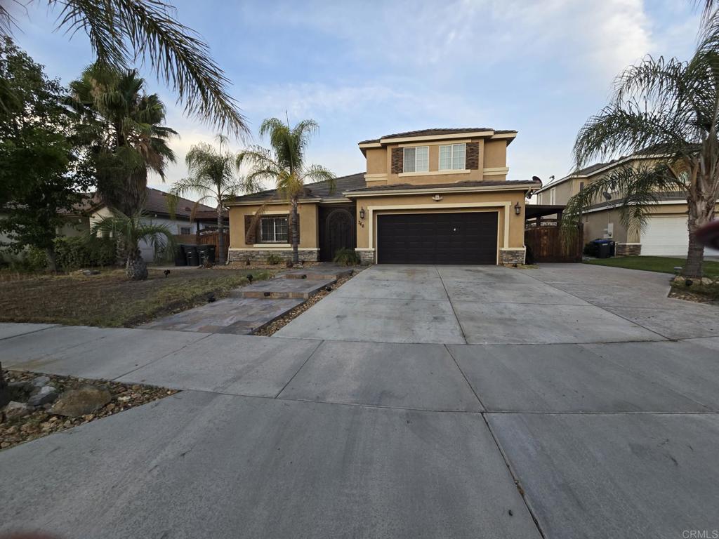 This delightful home in Menlo Estates is nestled on a cul-de-sac, featuring an elegant stamped concrete walkway and a custom iron gate at the entrance. Inside, the open floor plan showcases hardwood and tile floors throughout, with a convenient bedroom and bathroom located on the main level. The living and dining areas seamlessly connect to a cozy family room, complete with a fireplace, while the kitchen offers an eat-in space and comes equipped with all appliances. On the upper level, you'll discover three additional bedrooms, two bathrooms, and a laundry room. The primary suite is a true retreat, featuring dual sinks, a walk-in closet, and a separate tub and shower for added comfort. Outside, you'll find generous parking on both sides of the home, a covered patio, and a built-in gazebo BBQ area with appliances that will remain. The garage is versatile, ideal for parking or entertaining, and includes built-ins, ceiling fans, and a bathroom (plumbing installation will be the buyer's responsibility).