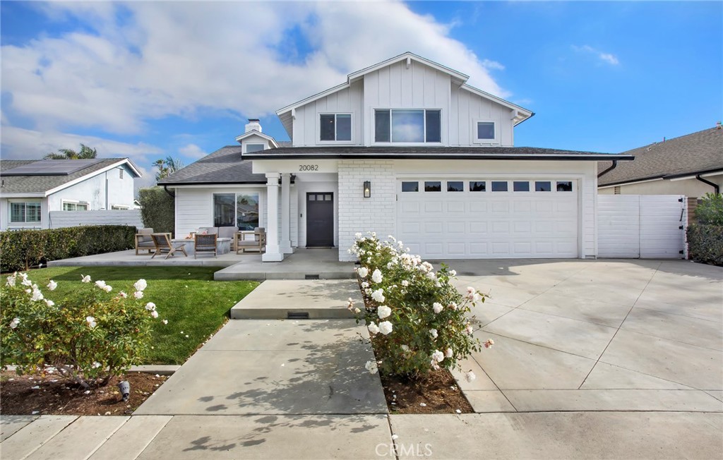 HUNTINGTON BEACH - Impeccably remodeled, expanded and upgraded throughout and showcasing a desirable Modern Farmhouse vibe in South Huntington Beach, this large upscale home is completely turnkey. An address within the highly sought-after Summerfield enclave near Drew Park complements the residence, which makes all feel welcome with a spacious front patio warmed by an open-air fireplace. Masterfully maintained landscaping, board-and-batten siding, white brick accents and a Dutch entry door characterize the exterior, setting the stage for an equally impressive interior that extends approximately 2,338 square feet. A vaulted ceiling soars high over the foyer, which offers views to the backyard and showcases a dramatic multi-tiered staircase. To the left, a formal living room wraps around the staircase and opens to the side yard via French doors, and a skylight allows natural light to illuminate the area. Gather with friends and loved ones in an open-concept dining room and kitchen that continue seamlessly to a custom family room with vaulted open-beam ceiling, white-brick fireplace with raised hearth, and French doors that open directly to the backyard. The kitchen is a showplace of today’s most desirable appointments, including quartz countertops, a full tile backsplash that reaches the ceiling, white Shaker cabinetry, shiplap wall treatment, peninsula bar, farmhouse sink and stainless steel appliances. Four bedrooms and three baths are featured in the move-in-ready home, ensuring comfort and privacy. Owners will appreciate a custom primary suite with vaulted ceiling, evening-light views over the neighborhood, a large walk-in closet with built-ins, and a sitting area. Not to be outdone, the primary bath shines with quartz countertops, Shaker cabinets, a bay window with freestanding tub, a skylight, shiplap accent wall, two sinks, and a spa-caliber shower with frameless glass enclosure. From upgraded dual-pane windows and glass doors to recessed lighting, wide-plank luxury vinyl flooring, ceiling fans and remodeled baths, every aspect of this home reflects a dedication to craftsmanship and enduring value. Take full advantage of Southern California’s renowned climate in an expansive backyard with swimming pool, spa, lawn, and sun and shade patios. Residents of the Summerfield neighborhood enjoy a beach-close setting served by excellent schools. There are no HOA fees, and shopping centers, the Huntington Beach Pier and Pacific City are only minutes from home.