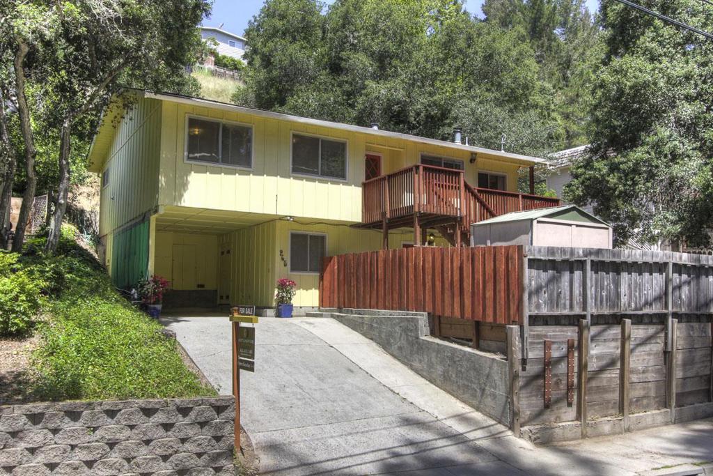 IDEAL STARTER HOME OR RENTAL! Large 4 Bedroom, 2 bath home with flexible floor plan. Downstairs has tile flooring in big family room with wet bar & wood stove, 1 bedroom & bath, + separate entry. Could be home office, art studio, guest quarters or? Newer redwood deck, carpet & paint. Fireplace in living room. Big sunny deck & patio. Move in condition with updating potential. Great commuter location. Short walk to Vine Hill School. Don't miss this opportunity to own an affordable home!