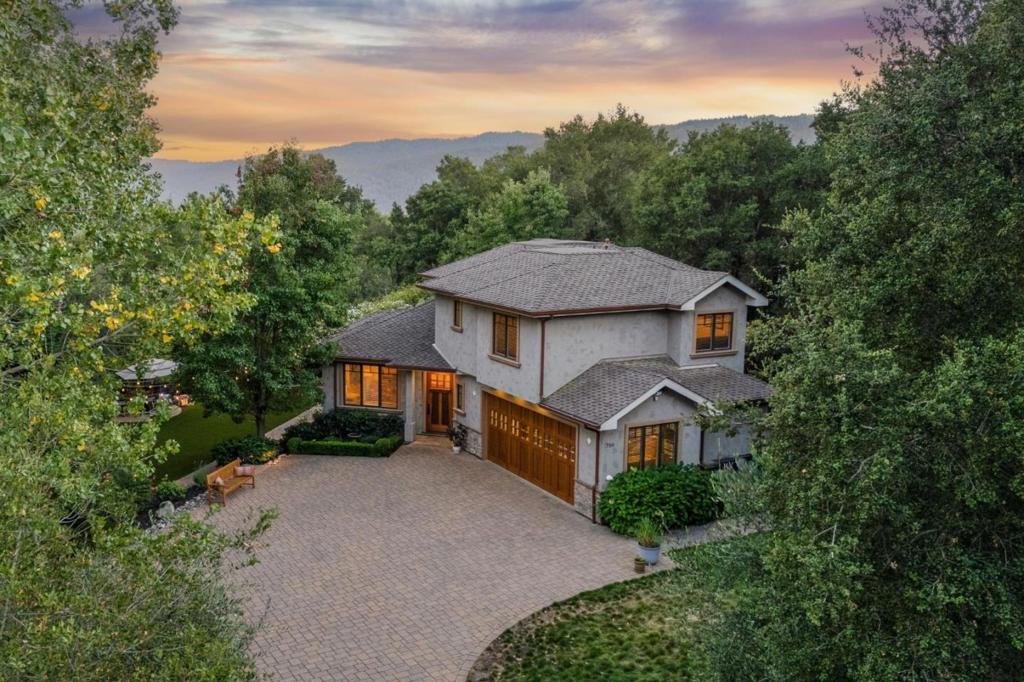 Refined Country Luxury on a Gated Level Lot Set beyond a gate on a spacious level lot, this newer home offers luxurious quality with an open and bright floor plan. Bamboo floors with a hewn finish, coved crown moldings, solid wood doors, and up-lit tray ceilings exemplify the quality details found throughout. The open design revolves around a spacious foyer with a formal living room, dining area, chefs kitchen with breakfast bar, and family room. There is a dedicated office, perfect for todays work-from-home needs, plus 3 upstairs bedrooms, including the primary suite with Western hill views and marble bath. Outside, the newly landscaped grounds unfold as a private retreat with mature trees and an expansive lawn, all with newly added lighting for evening enjoyment. A vibrant rose garden adds color, a welcoming patio invites effortless al fresco dining and entertaining, plus there is a raised bed succulent garden. Adding to the appeal is the homes close-in convenience just over 2 miles from the Woodside Village and with access to acclaimed Woodside Elementary School.