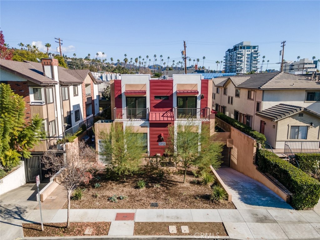Welcome to this beautifully updated 2-bedroom, 2.5-bathroom townhome offering 1,117 square feet of modern living in a highly desirable Glendale location. Built with comfort and function in mind, this two-story residence features an open floor plan with elegant laminate flooring, recessed lighting, and sleek baseboard moldings throughout. The spacious living area flows seamlessly into a well-appointed dining space and a contemporary kitchen equipped with stainless steel appliances, quartz-style countertops, and warm wood cabinetry. A convenient guest bathroom is located on the first level, while sliding glass doors open to a private patio—ideal for relaxing or entertaining. Upstairs, you’ll find two generously sized bedrooms, each with its own ensuite bathroom, offering comfort and privacy. Additional highlights include an in-unit laundry area, ample storage options, and an attached garage with an EV charger plug-in. Enjoy being moments from local favorites such as Trader Joe’s, Starbucks, Ralphs, and a variety of restaurants, shops, and markets. This turnkey home offers an ideal blend of style, convenience, and location in one of Glendale’s most accessible neighborhoods.