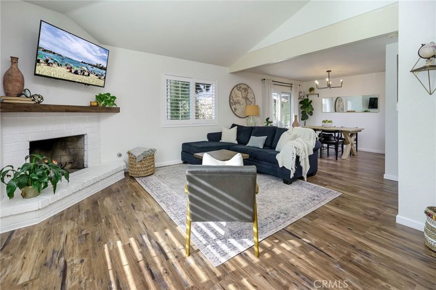 Highly Upgraded & Move-In-Ready 3-Bedroom Home in Eastside Costa Mesa! Premium END UNIT Location - Only Attached on One Side - with an Oversized 2-Car Attached Garage, 2 Parking Spots in the Driveway, and an Additional Assigned Parking Spot - Total Parking for 5 Cars! All Newer Dual-Pane Windows & Sliding Glass Doors, Handsome Luxury Vinyl Plank Flooring, Shiplap Accents, Custom Light Fixtures & Elegant Plantation Shutters Throughout - Charming Dutch Entry Door Opens to Spacious Living Room Boasting a Vaulted & Beamed Ceiling and Brick Fireplace with Hearth & Custom Wood Mantle - Dining Room - Stunning Remodeled Kitchen Features Custom Soft-Close Cabinetry with Pull-Out Shelves, Stone Countertops with Full Backsplash, Recessed Lighting, and All Stainless-Steel Appliances, Including Gas Cooktop, Convection Oven, Microwave & Custom-Sized Refrigerator Chosen to Maximize Space - Custom Designed Wood & Iron Staircase Leads Upstairs to 3 Good-Sized Bedrooms, Including Primary Suite with Walk-In Closet - All Bathrooms Beautifully Remodeled with New Stone Vanities, Stylish Tile Flooring, Toilets, Light Fixtures, Mirrors & More - Two Bedrooms Share a Large Balcony Deck Off the Front of the Home - Backyard Patio is a Lovely Spot to Sit & Enjoy the Outdoors - This Small Cul-De-Sac Community of Only 6 Homes is Located Just Minutes from the Beach, Airport, OC Fair & Event Center, Parks, Golf Courses and Endless Shopping, Dining & Entertaining Options - No Mello Roos Tax
