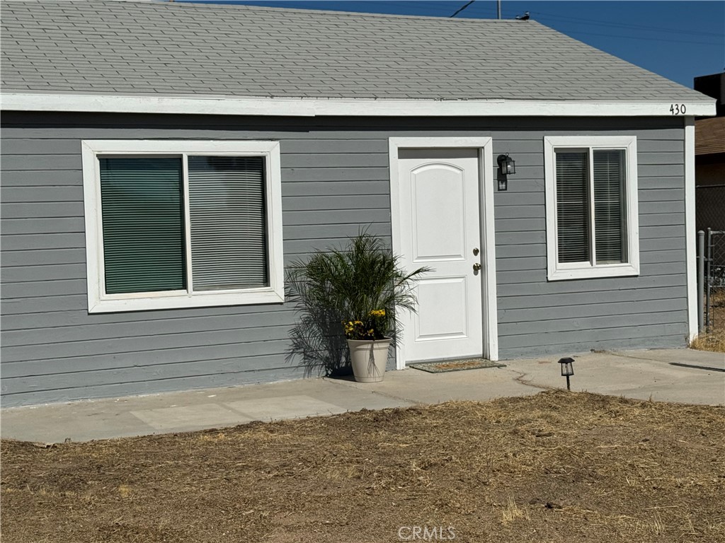 Welcome Home! Zoned R-3! This single-story with a simple and modern design home is move-in ready! It has a clean, light gray exterior with white trim around the windows and door. The house is situated on an open lot with a path leading to the entry. The fenced yard provides a sense of privacy. This is a large lot with an opportunity for expansion as it is Zoned R-3, meaning an additional 2 units could be built on this lot. The existing home offers the ability to live here as you expand and build the other units! Completely remodeled in 2022, this home offers a nice open floor plan with a great room as you enter that can be a dual living space with a dining area. Featuring laminate flooring throughout and newer carpet in the bedrooms, newer doors and windows, recessed lighting, an indoor laundry room, ceiling fans in bedrooms, and newer closet doors. The lot is large enough to park and store 1 or more RVs with a gate access door. Both the front and back yards are a clean slate for your creative ideas. The open kitchen offers granite countertops and newer cabinets, a dishwasher, a stove overhead exhaust fan and double-sided sink with a detachable faucet sprayer. Come and check this one out, before it's too late! This is an ASSUMABLE LOAN AT ONLY 2.75% , additional assumable loan information is available.