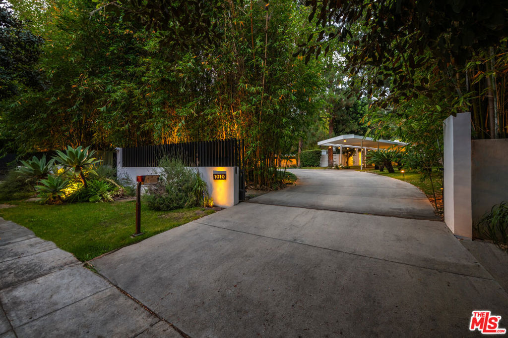A true architectural gem by master architect A. Quincy Jones, AIA, this mid-century masterpiece is nestled in the heart of Beverly Hills on a rare street-to-street 1.2-acre lot north of Sunset. Exemplifying timeless California modernism, the home showcases original mid-century details including iconic floor-to-ceiling glass walls that flood the interiors with natural light, terrazzo flooring, fieldstone accent walls, and a classic step-down bar. The open-concept layout seamlessly connects expansive living and dining spaces to multiple patios and outdoor spaces, ideal for effortless indoor-outdoor living. The primary suite offers a serene retreat with a cozy fireplace, dedicated relaxation lounge, and a spa-inspired bath, all opening to a lush, park-like backyard complete with a swimmer's pool and N/S tennis court. A thoughtfully designed two-unit guest house complements the original architecture, providing additional space and privacy while honoring the legacy of Jones' vision. This is a rare opportunity to own a residence that combines architectural integrity and historic significance.