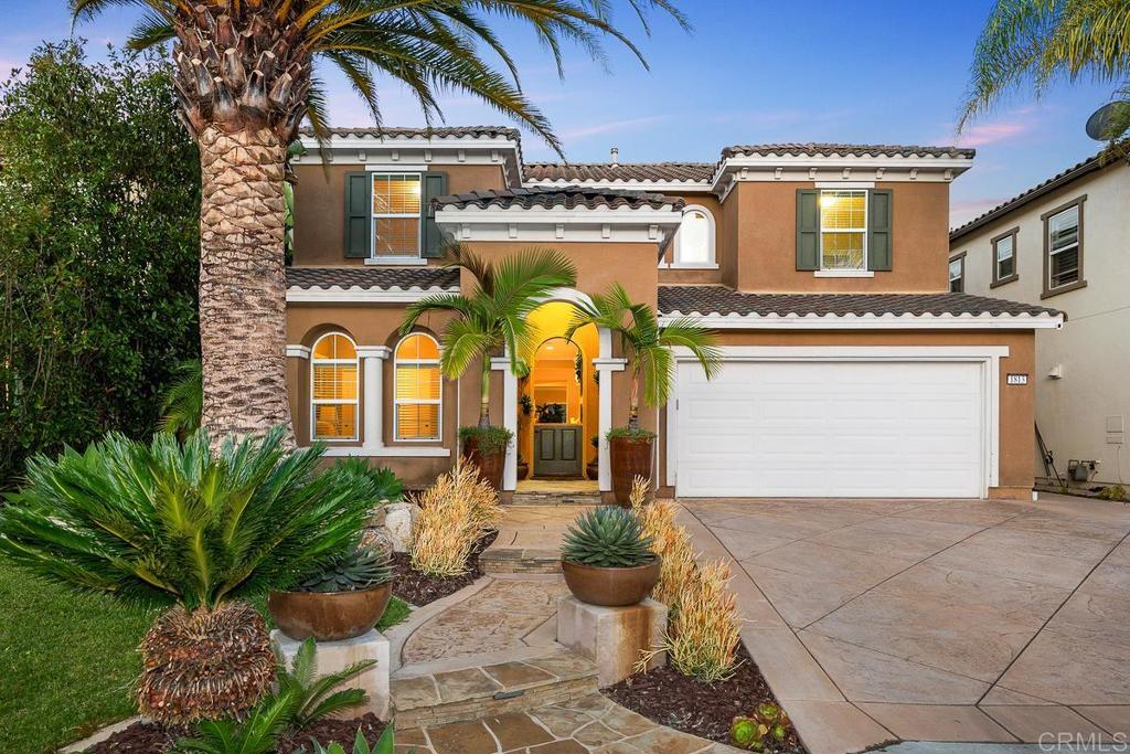 Stunning Entertainer’s home with gorgeous pool and true California indoor/outdoor living! Located in the highly desirable Venzano community, this exquisite home has everything you could dream of, including a recently remodeled modern kitchen, new luxury vinyl plank flooring upstairs, new windows and updated lighting and fixtures throughout. La Cantina doors open to a private backyard oasis with a beautiful pool featuring a Baja shelf, spa with waterfall feature, and built-in BBQ with outdoor fridge. With 3,437 sq ft, this home offers 5 bedrooms, 4 bathrooms, PLUS an office and loft. The chef’s kitchen boasts white shaker cabinetry, soft-close drawers, a large Quartz double waterfall island, custom pendant lighting, herringbone tile backsplash, and newer stainless steel appliances including a Dacor built-in fridge, range/oven with custom hood, double ovens, Bosch dishwasher, wine fridge, and appliance garage. In addition to the walk-in pantry, there's a spacious butler’s pantry with a second wine fridge and abundant storage. The home is distinct and welcoming with a Canary Date palm, mature tropical landscaping, a stamped concrete driveway, and a Dutch door for ocean breezes. Main level includes a full bed and bath, large living/dining room combo, and an office with custom built-ins. Upstairs features 4 additional bedrooms, 3 bathrooms, a loft, and a generous primary suite with dual closets, jetted tub, and large shower. Also includes OWNED solar for house and pool, A/C, tankless water heater, laundry room, and a 2-car garage with storage. Just steps to popular Questhaven Park and close to trails, town center, and top-rated San Elijo Hills schools, zoned for San Marcos High.