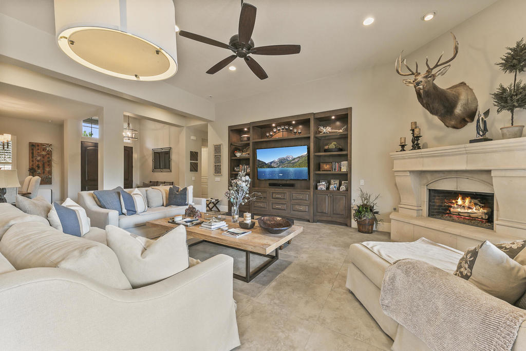 This stunning 4BR/4BA, 3,150 sq. ft. residence has been transformed with top-of-the-line finishes, custom craftsmanship, and thoughtful design throughout. Energy efficiency meets comfort with paid solar, a Retrac sunscreen for shade, and a misting system, while the backyard is a true entertainer's paradise--featuring a sparkling pool and spa, outdoor kitchen with BBQ, Infratech patio heaters, vegetable garden beds, and lush landscaping. The front entry sets the tone with new double doors and hardware, a redesigned walkway and courtyard with pavers, and impeccable curb appeal. Inside, every detail has been elevated--solid wood interior doors with Emtek hardware, new porcelain tile flooring, lifetime warranty wool carpet in two bedrooms, expanded hallways with upgraded baseboards, custom window coverings, all LED lighting, and upgraded Lutron Satin Screwless devices. The gourmet kitchen is a showstopper, showcasing custom cabinetry, a massive 9'x7' island with storage, granite countertops, double dishwashers, an oversized stainless sink with air switch disposal, custom pendant lighting, and an upgraded 10.5' sliding glass door opening to the outdoor kitchen. Additional highlights include a built-in entertainment center, limestone-surround fireplace, and custom wet bar with Uline beverage and wine refrigerators. The home offers two primary suites, each with ensuite baths, including one with a custom shoe and purse closet, marble countertops, standalone tub with feature wall, Kohler sinks and toilets, and premium PH plumbing fixtures. Guest quarters and the second primary boast new tub/shower enclosures, custom cabinetry, built-in closets, and upgraded plumbing fixtures. A relocated and expanded laundry room with custom cabinetry, a fully outfitted garage with epoxy floors and storage, and thoughtful touches throughout complete this move-in-ready masterpiece designed for luxury living and effortless entertaining.