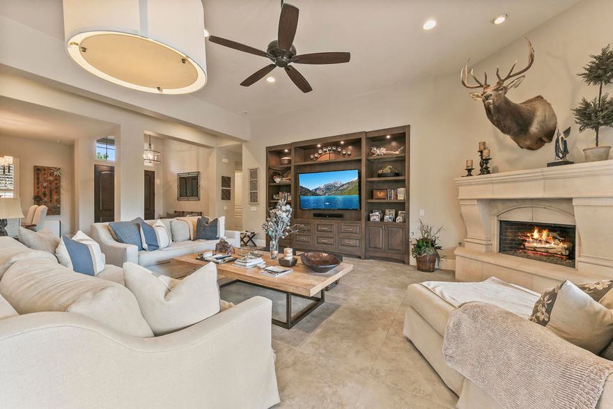 This stunning 4BR/4BA, 3,150 sq. ft. residence has been transformed with top-of-the-line finishes, custom craftsmanship, and thoughtful design throughout. Energy efficiency meets comfort with paid solar, a Retrac sunscreen for shade, and a misting system, while the backyard is a true entertainer's paradise--featuring a sparkling pool and spa, outdoor kitchen with BBQ, Infratech patio heaters, vegetable garden beds, and lush landscaping. The front entry sets the tone with new double doors and hardware, a redesigned walkway and courtyard with pavers, and impeccable curb appeal. Inside, every detail has been elevated--solid wood interior doors with Emtek hardware, new porcelain tile flooring, lifetime warranty wool carpet in two bedrooms, expanded hallways with upgraded baseboards, custom window coverings, all LED lighting, and upgraded Lutron Satin Screwless devices. The gourmet kitchen is a showstopper, showcasing custom cabinetry, a massive 9'x7' island with storage, granite countertops, double dishwashers, an oversized stainless sink with air switch disposal, custom pendant lighting, and an upgraded 10.5' sliding glass door opening to the outdoor kitchen. Additional highlights include a built-in entertainment center, limestone-surround fireplace, and custom wet bar with Uline beverage and wine refrigerators. The home offers two primary suites, each with ensuite baths, including one with a custom shoe and purse closet, marble countertops, standalone tub with feature wall, Kohler sinks and toilets, and premium PH plumbing fixtures. Guest quarters and the second primary boast new tub/shower enclosures, custom cabinetry, built-in closets, and upgraded plumbing fixtures. A relocated and expanded laundry room with custom cabinetry, a fully outfitted garage with epoxy floors and storage, and thoughtful touches throughout complete this move-in-ready masterpiece designed for luxury living and effortless entertaining.