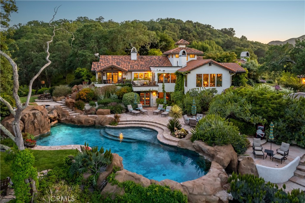 This stunning ±4,000 sq ft, 4-bed, 4-bath home sits on 5 private acres with breathtaking views of Atascadero and Three Bridges Oak Preserve. Fully updated with new floors, plumbing, electrical, luxury appliances, custom cabinetry, and vaulted ceilings throughout. Features include 3 fireplaces, a show-stopping pool with waterfall and oversized in-ground custom stone hottub. The 3-car garage includes a rear roll-up door opening to a cantilevered deck overlooking a beautiful oak preserve and an office with its own bathroom and French doors. Bonus 40x20 steel building for storage or hobby use. 1.5 acres fully fenced. A rare blend of luxury, privacy, and natural beauty.