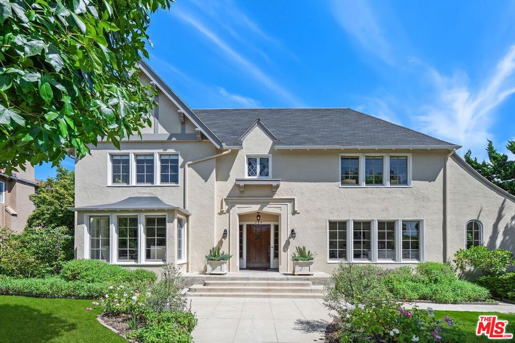 Which traditions will you carry on and which will you create? This 1922 Country English, offered by only its second owner, blends timeless architecture with space to imagine what is next. For 65+ years it has been filled with music, conversation and celebration. Light streams through a gracious center hall plan, where hardwood floors, detailed moldings and vintage fixtures reveal true craftsmanship. From the entry, the home opens to both the expansive living room - with three exposures and a fireplace - and the formal dining room, creating a natural flow for entertaining and everyday living. The dining room connects to a butler's pantry and kitchen, while a den with fireplace opens to a covered patio and deep backyard, ready for gatherings or future vision. A breakfast room, bedroom and full bath complete the downstairs. Upstairs, four large bedrooms and two baths offer flexibility for work, retreat, or expansion. Situated in Windsor Square HPOZ on one of Lorraine's largest lots, just blocks from Larchmont Village, this is a rare opportunity to plant roots in a neighborhood prized for both history and stability while shaping it to reflect your own way of life. 3rd Street Elementary.