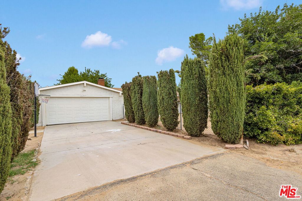 Welcome to this beautifully renovated ranch-style home, perfectly situated on a large 20,000-square-foot corner lot. Offering 2,000 sq ft of living space, this residence features five generously sized bedrooms and three updated bathrooms. The open floor plan seamlessly connects the living, family room, and the gourmet kitchen with a spacious island, stylish finishes, and top-of-the-line appliances perfect for creating memorable meals. Throughout the main home, you'll find rich wood floors and tasteful, modern updated Bathrooms that elevate the space. Adding even more value, this property includes a detached 800 sq ft bonus structure ideal as a guest house, ADU, studio, or storage. This versatile second structure features its own living area, bedroom, bathroom, and kitchenette. This move-in-ready property combines modern luxury, abundant space, and is truly a rare find in Apple Valley!