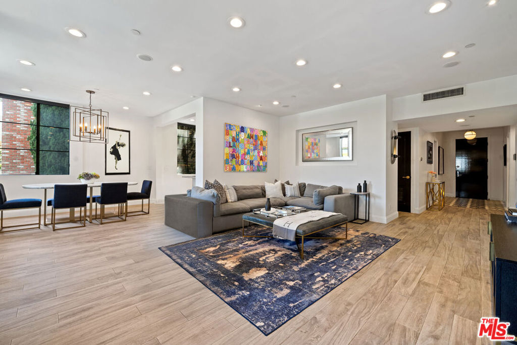 Rarely available, front-facing Beverly Hills condo updated with impeccable taste and high-quality finishes, ideally located just off South Beverly Drive with effortless access to the city's finest dining, shopping, and everyday conveniences.This stylish second-floor residence (the first floor of the building is the lobby) offers an open floor plan with abundant natural light throughout. The spacious living and dining areas flow seamlessly to a lengthy balcony framed by lush treetop viewsperfect for entertaining or simply relaxing. The sleek modern kitchen is beautifully appointed with granite counters, custom under-lit cabinetry, stainless steel professional-grade appliances, and an eat-in bar counter.The lavish primary suite features a private balcony, huge walk-in closet with built-ins, and a spa-inspired bath with marble and gold finishes, dual vanities, soaking tub, steam shower, and heated floors. The second en-suite bedroom, currently configured as a podcast studio and content creator's lounge, offers unique versatility and can easily be transitioned back to a full bedroom suite.Additional highlights include a large in-unit laundry room, two parking spaces plus guest parking, and a secure building with updated key entry system and elegant lobby. This bright, airy corner unit lives like a single-family home, all just steps from South Beverly Drive, Rodeo Drive, and everything Beverly Hills has to offer.