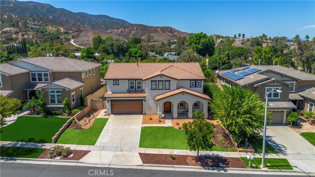 ***UPGRADED SOUTHWEST CORONA VIEW HOME*** Nestled on a quiet street with no rear neighbors, this beautifully enhanced home offers sweeping views of the Cleveland National Forest and city lights all with NO HOA. From the moment you arrive, the fresh exterior paint, upgraded garage door, and custom front entry create exceptional curb appeal. Upon entry you'll find upgrades including, engineered hardwood flooring, a stunning wood-and-wrought-iron staircase, new windows, canned lighting and more. Featuring a formal living and dining room, chef’s kitchen that has been thoughtfully redesigned with a large center island, custom cabinetry, and seamless flow into the open family room, ideal for entertaining and everyday living. A built-in desk in the family room provides a perfect workspace while the fireplace provides the perfect spot for those cozy cravings. Upstairs, a spacious loft offers flexibility for your needs and leads to a large balcony that spans the rear of the home an ideal spot to enjoy peaceful shade and panoramic views. The primary suite features private balcony access, a spa-inspired bathroom featuring a whirlpool soaking tub, mirrored closet doors, and upgraded fixtures and vanity, a walk in closet with built-in drawers and cabinetry. Dont pass by the exceptionally remodeled guest bathroom and shower and the fully remodeled laundry room with custom cabinetry that combines beauty with function. Step outside to a peaceful and private backyard with a full patio cover from the above balcony and no homes behind. A gas line has been run for outdoor cooking, new light fixtures are set on timers, and the rod iron backyard fence and gate have been replaced.The sprinkler system and control panel ensure easy maintenance. Hosting guests is no problem with the home's extended driveway that can accommodate up to four mid-size SUVs. Additional upgrades include, smart-home features including hardwired security cameras, a wired alarm system with sensors, remote-controlled fans throughout, and all-LED lighting in closets and pantry. Comfort and efficiency are supported by a whole-house water softener, reverse osmosis drinking system, whole-house water filtration system, and a newer water heater. Enjoy the space of a 3car tandem garage! With extensive upgrades throughout, a functional and flowing layout, and an unbeatable location near the 91, 71, and 241 freeways, this home-with-a-view is a rare opportunity in one of Corona’s most sought-after neighborhoods.