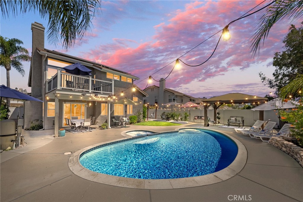 Welcome to your private retreat in the heart of Murrieta! This beautifully updated 4-bedroom, 3-bathroom home offers 2,318 sq ft of thoughtfully designed living space on an expansive 7,500 sq ft lot. With a versatile layout, stylish finishes, and a dream backyard, this home checks every box. Step inside to discover a light-filled open floor plan with elegant porcelain and LVP flooring throughout, granite countertops that seamlessly flow through the kitchen and baths, and updated touches that elevate every corner. The kitchen opens to the living and dining areas, perfect for everyday living and entertaining alike. Upstairs, take in panoramic views of the Temecula Valley from the private balcony—an ideal spot for morning coffee, evening wine or catching the 4th of July fireworks. The primary suite features a spa-like bathroom with dual vanities, a soaking tub, and a separate walk-in shower. But the true showstopper? The entertainer’s backyard. Dive into the sparkling pool, relax under the custom-covered patio, gather around the fire pit, or sway in the hanging hammock beneath string lights. This outdoor space offers the perfect balance of serenity and celebration. This home has been thoughtfully enhanced with modern conveniences and stylish upgrades, including brand new EverLights on the exterior—customizable for every holiday or event and controlled with an app—solar lighting throughout the backyard, new vinyl fencing, and a saltwater pool with newer equipment. Additional highlights include a brand new HVAC system, fruitful citrus trees, a charming gazebo for shaded lounging, Solar panels for energy efficiency, lush landscaping, and a prime location just minutes from shopping, dining, Murrieta’s top-rated schools, and Temecula Wine Country. There’s truly so much more to see— Don’t miss this rare opportunity to own a view home with a resort-style yard in one of Murrieta’s most sought-after neighborhoods!