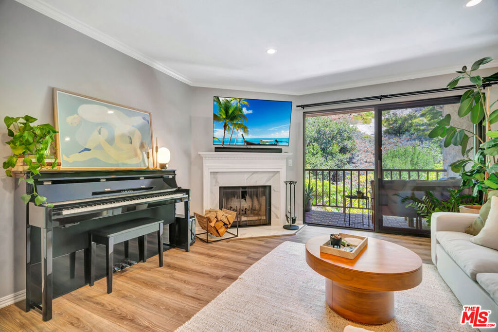 Set in a peaceful location with picturesque views of a lush hillside and trees, this charming 2-bedroom, 2-bathroom condo in the Monterey Hills neighborhood of Highland Park offers a tranquil atmosphere, complete with a cozy balcony patio perfect for enjoying the outdoors. Inside, the open floor plan is bathed in streams of light, creating a warm and inviting ambiance. The home features freshly updated flooring, modern lighting, fireplace, and a Nest thermostat. The kitchen is designed for both functionality and style, featuring sleek countertops, a breakfast bar, state-of-the-art appliances, and plenty of storage space. Step outside onto the balcony to unwind and take in the peaceful views of the lush hillside. The primary suite, filled with natural light, has its own private bathroom, offering a peaceful retreat. On the opposite wing of the unit, the second bedroom boasts ample closet space, with a full bath and a dedicated laundry area featuring side-by-side LG washer and dryer. Additional highlights include recessed lighting, central AC and heating. Two tandem parking spaces in a gated garage offer convenience and security, while the community provides desirable amenities such as a pool, spa, recreation room, and 24-hour security surveillance. Located near the stunning Debs Park and just a short distance from local Highland Park favorites like Home State, Kitchen Mouse, Trader Joe's, and Fresco Supermarket, this condo provides everything you need for an easy, enjoyable lifestyle. With a low HOA fee of $520 covering water, sewer, trash, common area maintenance and insurance. This move-in-ready condo is a must-see! Schedule your tour today and experience all that this lovely home has to offer!