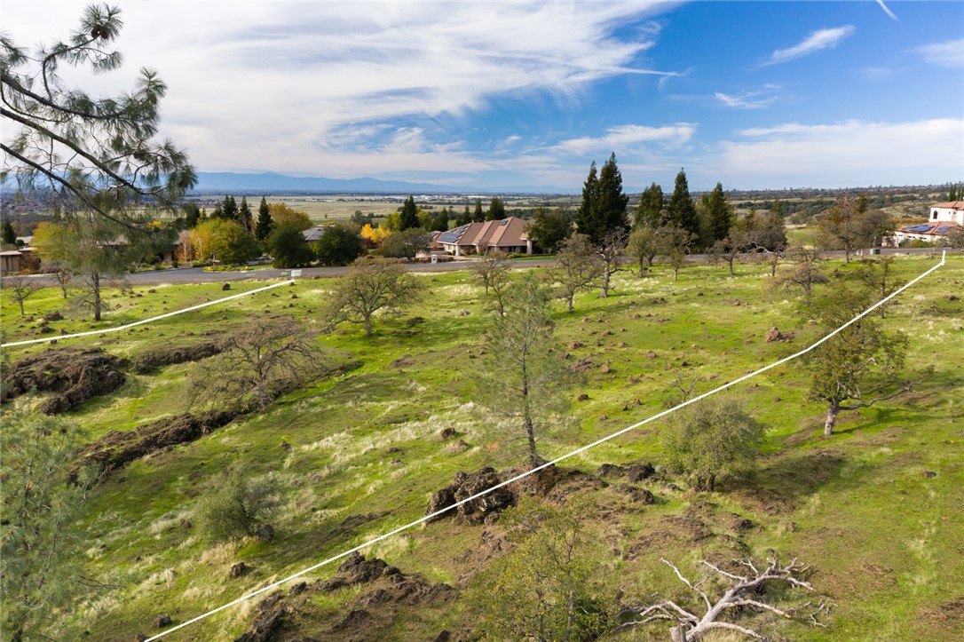 This exceptional 2.93-acre lot in the prestigious Canyon Oaks community offers a rare chance to build the custom home you’ve always dreamed of. This property is perched at a higher elevation above the city of Chico, providing breathtaking, unobstructed views of sunrises, sunsets, and incoming storms—a true retreat surrounded by natural beauty. You'll enjoy the privacy of a gated golf course community with two secure, gated entrances, as well as direct access to the scenic walking and biking trails of historic Bidwell Park. The rear of the parcel slopes gently with striking rock outcroppings that enhance its unique character.