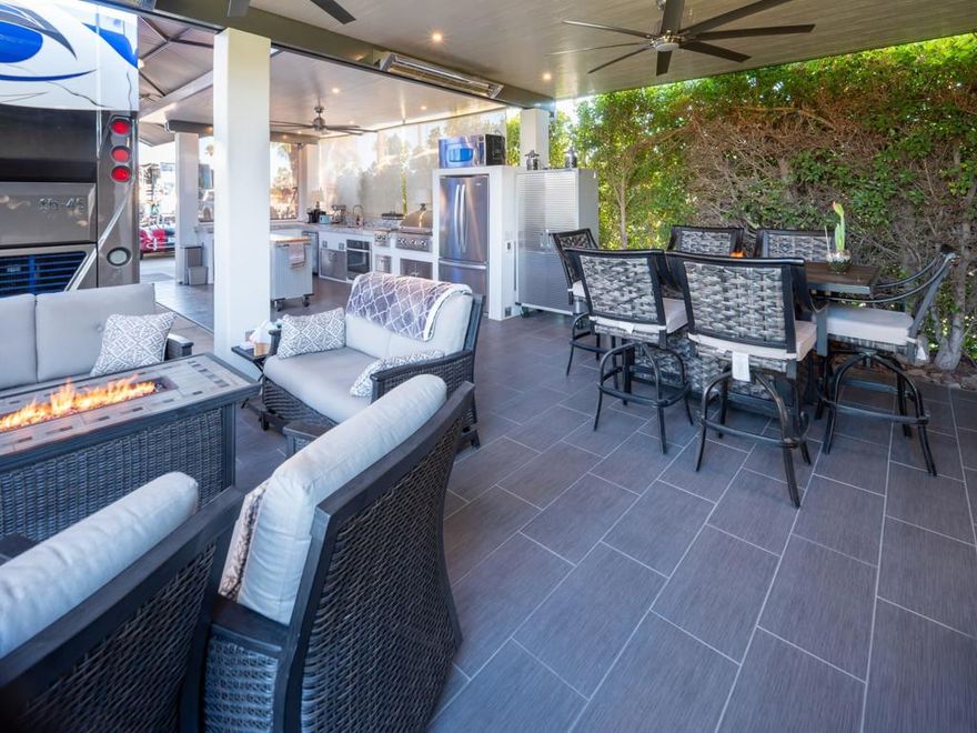 Entertain with friends or enjoy serene privacy in unmatched luxury at lot #187 at Outdoor Resort Indio. Built in 2022, this turnkey lot boasts one of the valley's only heated tiled floors, a pergola with an insulated Alumawood roof (keeping it up to 20 degrees cooler), and features like three reversible fans, roof lights, sconces, and ceiling heaters for those cool evenings. The outdoor kitchen is fully equipped with granite countertops, stainless steel appliances, a gas cooktop, oven, full fridge, built-in BBQ, and fire-feature tables for warm, inviting evenings. Two electric shades, manual shades, and custom protective covers ensure maximum comfort and style.Designed with both luxury and practicality in mind, this lot is near the pool, new 2022 plumbing, and ample outlets. It easily accommodates a 45-foot motorcoach, extra parking, and even a negotiable golf cart. Security is covered with three wired and solar infrared 360 cameras and lights, while the outdoor entertainment center with internet and a projector TV makes it perfect for hosting. The lot orientation offers great sun protection and stunning sunsets, while plans are approved for a privacy wall with a walk-in closet. If you are a pool lover, this lot has access from the rear of the lot towards the pool area and golf course. This secluded and thoughtfully designed lot is your chance to own a truly unique piece of Outdoor Resort Indio.Outdoor Resort Indio is a class A only motorcoach resort in Indio, California.