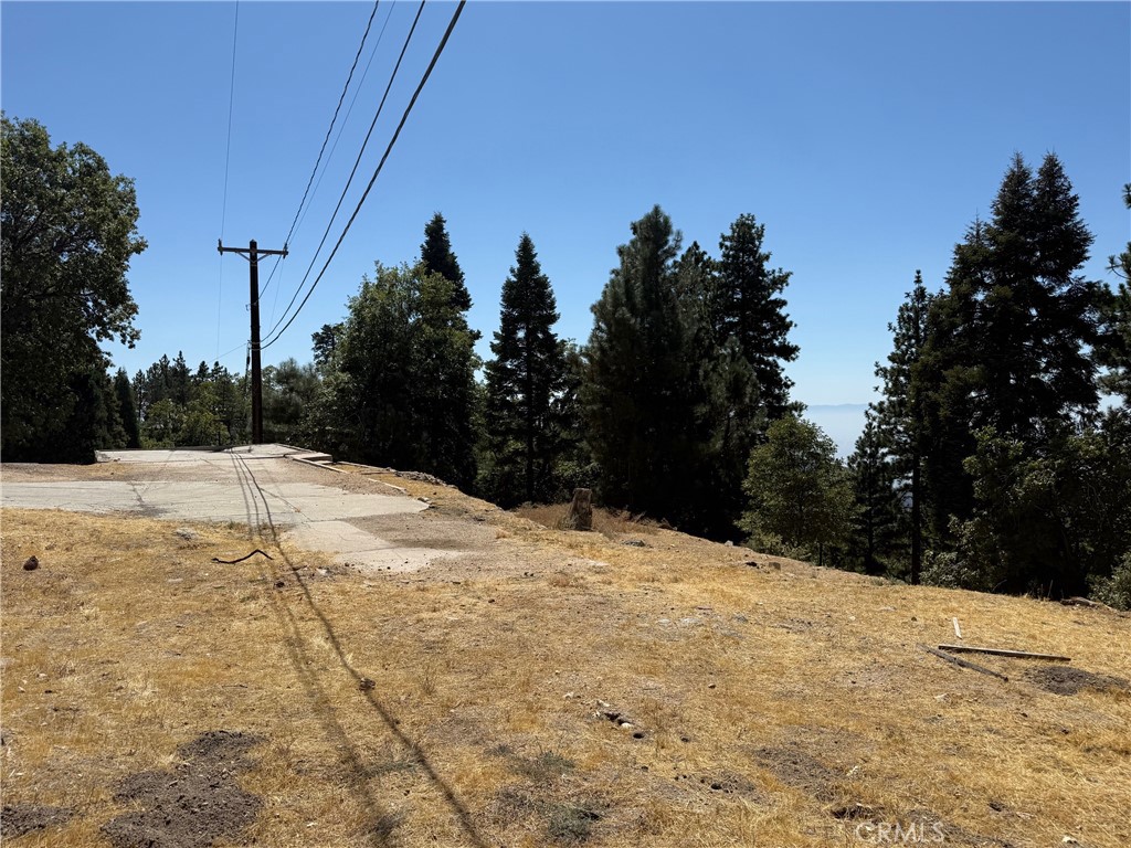Great Opportunity to build on this 28,370 sqft Gentle Downslope Lot situated in the Community of Smiley Park Country Club which is located off of Highway 330 and Fredalba Road about 2 miles prior to the Running Springs Exit. Ideal Level Entry from Street was the previous home that existed on this site prior to the Fire of 2003 boasted distant San Bernardino City Light Views! Foundation remnants exist and the condition of the pre-existing Septic System is unknown. Survey is On File, Water Line at Street and the Electricity is overhead, Propane Tanks are permitted as there are no Natural Gas Lines present in the Smiley Park Community Development. Smiley Park HOA does NOT allow Manufactured Homes, and ownership operates under a 99-year lease, which renews automatically with any change of ownership for another 99 years. HOA Fees are currently at $208.00 per month, which covers Snowplowing and Road Maintenance, Assessments, Liability Insurance and the Use of the Smiley Park Clubhouse Game Room, Pool and Patio Area. Of the current $208.00 Monthly HOA Fees, $132.73 is applied to Assessments and the remaining $75.27 is applied to the Reserves. Water is not included in the monthly HOA Fees and is billed Quarterly. The HOA strives to keep any HOA Due Increases at no more than 10% per year and has substantial reserves. The Smiley Park Neighborhood is an Ideal Location for ease of commuting up and down the Mountain with all the local destinations of Snow Valley Ski and Big Bear Ski Sope Areas, Sky Park and Lake Arrowhead Village merely at your fingertips.