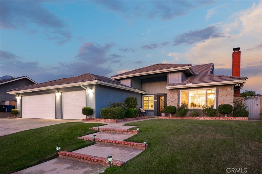 Elegant Living Near Upland’s Best Shopping & Dining! Located in a highly desirable area of North Upland, this single-story home has been lovingly improved and maintained by its original owners, and is now being offered for sale for the first time since it was originally built. The property offers a prime location close to shopping, dining, and Upland Hills Country Club. Featuring lush landscaping, a three-car garage, and gated side access with room for additional vehicles or RV parking. Through the beautiful custom double front doors, natural light fills the well-planned layout. The living room is anchored by a welcoming fireplace and framed by large windows with views of the front yard. The formal dining room flows openly from the living room, creating a welcoming space for gatherings. The kitchen is thoughtfully designed with granite countertops, and stainless steel appliances including double ovens, and a built-in gas cooktop. Ample counter and cabinet space make meal preparation a joy. Just beyond the kitchen, a breakfast nook provides the perfect setting for casual meals with backyard views. The spacious family room is ideal for entertaining, enhanced by high ceilings that bring openness and volume to the space. The home offers four sizable bedrooms and two bathrooms. The primary suite includes soaring ceilings, dual closets, one a walk-in, and an en suite bathroom featuring dual sinks and a walk-in shower. A private exit from the suite leads directly to the backyard. Additional upgrades to the house include dual pane windows, a new tankless water heater, and a 200 amp service panel. The backyard is expansive and designed for both relaxation and entertaining. At its center is a large pool and spa, perfect for cooling off on warm days or unwinding in the evenings. A covered patio offers a shaded retreat, while string lights add a beautiful ambiance after sunset. A dedicated gardening area provides space for planting, and multiple lounging options create an amazing atmosphere for gatherings of any size. Two storage sheds complete the backyard, adding practicality to the home’s inviting outdoor setting.