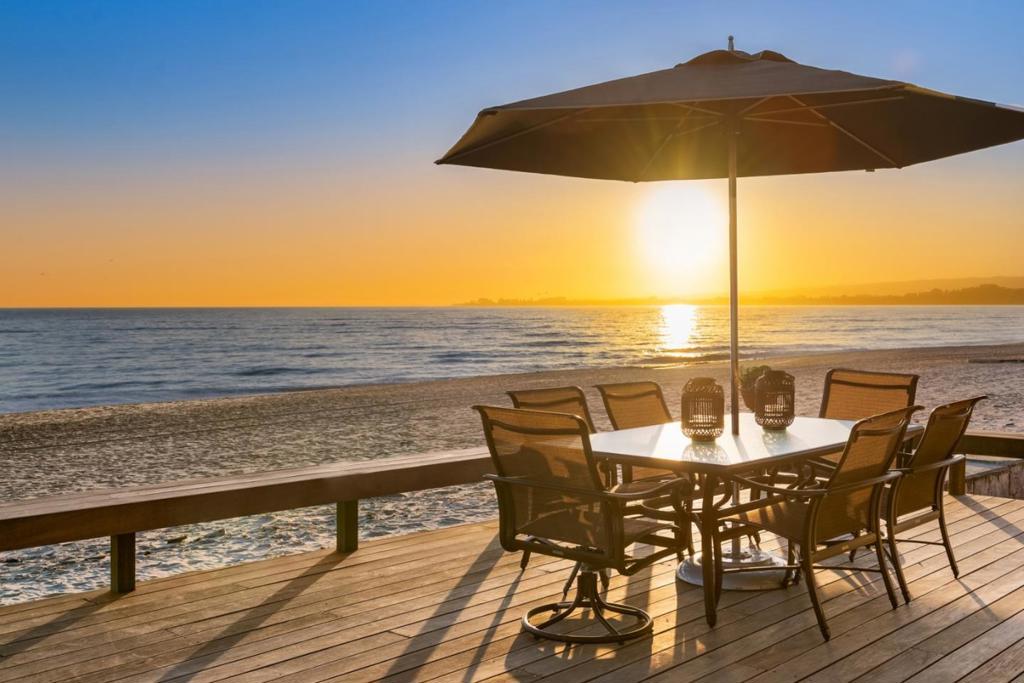 BIG $400,000 Price Drop! Oceanfront Luxury nestled behind private gates. This exquisite beach home is masterfully designed by renowned architect Thatcher Thompson & impeccably constructed by DeMattei Construction. A charming central courtyard beckons from behind an unassuming entry door, interconnecting different wings of the property through sliding doors & revealing a breathtaking coastal landscape. Every detail has been meticulously considered, ensuring a blend of comfort & sophistication. Step into an impressive great room, where high ceilings, big picture windows, & elegant finishes create an ambiance of grandeur. Adjacent, the equally stunning kitchen beckons with high-end appliances & an expansive island dining bar. Inside, find multiple places to relax & retreat, whether by the fireplace, in the cozy den, or on the expansive oceanfront deck. Immerse yourself in the serenity of coastal living with sweeping views from Santa Cruz to Monterey & steps leading directly to the sandy shore. Watch dolphins & whales play in the ocean, birds stroll along the sand, & sunsets paint the sky in hues of gold and pink. Restaurants & everyday amenities just a short distance away. A rare opportunity to embrace the lifestyle you've always dreamed of.