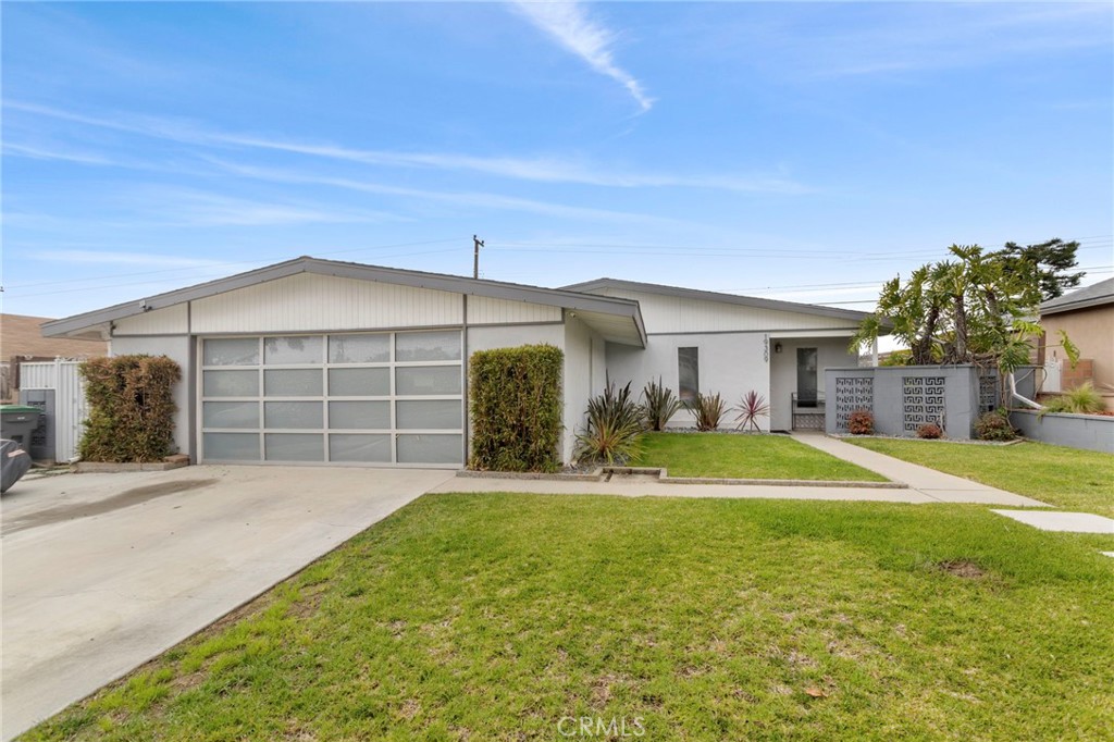 Welcome to a fantastic opportunity in North Carson! This incredible 3-bedroom, 2-bathroom home sits on a generous 6,280 sq. ft. lot. Step inside to a modern open-concept layout featuring soaring ceilings and beautiful bamboo flooring that create a bright, airy feel. The kitchen is well-equipped with stainless steel appliances and plenty of space, perfect for daily living. The spacious living room features a cozy fireplace for those relaxing evenings. This home also features a huge den with plenty of natural light due to this high ceilings and skylights. This room could be used as a home office, second living room, or room to possibly even add a 4th bedroom. The primary suite bedroom is also another great feature, large enough for a California king sized bedset and its own private bathroom, this room is its own oasis. The backyard is another highlight, with a spacious deck offering stunning city views and glimpses of the Palos Verdes Hills an ideal spot for gatherings. Additional features include a newer roof, energy-efficient dual-pane windows, and a modified garage that now serves as a versatile non conforming room and a separate laundry room. This home is located just minutes from the Carson/SouthBay Pavilion and with easy freeway access, this home combines comfort and convenience in a highly desirable neighborhood. One or more photos have been digitally staged.