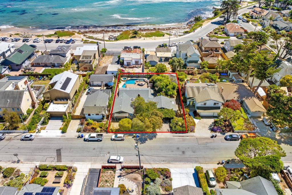 Rare Ocean-View Treasure: Expansive Lot Just Off West Cliff Drive. Discover a one-of-a-kind sanctuary nestled just one house off West Cliff Drive on a lot that's double the size of most in the neighborhood. Imagine your mornings wandering among mature trees, afternoons basking by a shimmering pool, and evenings enjoying the ocean breeze all within walking distance of Natural Bridges, Lighthouse Field, Steamer Lane, and the iconic Boardwalk & Municipal Wharf, with a lively array of restaurants and cafes nearby. The current residence is a canvas primed for transformation. Dream in three dimensions with professionally rendered plans that retain the existing detached office, add a one-car garage, expand the ADU, and build a two-story main home with an attached junior ADU. Envision climbing a staircase to your second-floor primary suite and great room with a wrap-around deck designed to deliver breathtaking swaths of ocean view. This is more than a home, it's a rare opportunity to create a custom beach compound where lifestyle, location, and luxury converge.