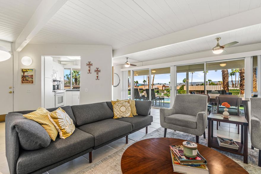 Mid-Century Sandpiper Gem! Step into the timeless allure of this classic Wm. Krisel-designed Sandpiper condo -- one of the original mid-century units that beautifully blends iconic architectural details with thoughtful updates. Signature exposed concrete block walls, tongue-and-groove ceilings, and walls of glass capture the essence of true desert modernism.This 2-bedroom, 2-bath home features tile flooring throughout the main living areas and carpeting in both bedrooms. The open-concept living and dining space is anchored by an updated kitchen with sleek cabinetry, laminate countertops, and modern appliances.Enjoy dual-paned poolside sliders that open to a spacious patio overlooking lush greenbelt views, the sparkling pool, and the northern mountain backdrop. The private patio off the primary suite offers a quiet retreat and includes convenient outdoor laundry.Both bathrooms maintain their mid-century character while incorporating updated vanities and fixtures.Located in one of Palm Desert's most desirable and historically designated sections of Sandpiper, this home is eligible for the Mills Act, offering potential property tax savings. Just minutes from the shops and restaurants of El Paseo, this mid-century treasure is ready to become your next desert retreat.