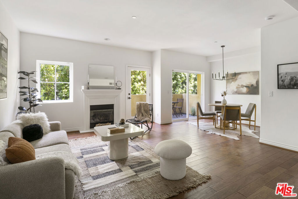 The perfect Studio City condominium. The entry foyer of this beautifully maintained single level unit leads to a light filled open living area with balcony for enjoying views or quiet contemplation. The living space features high ceilings, wood floors, recessed lighting, with separate dining area & a mantled fireplace, while the perfect gourmet kitchen features a Viking stove, custom cabinets & granite countertops. The Primary Bedroom has it's own terrace/balcony, walk in closet and tastefully updated bathroom. The spacious second bedroom also features an en suite bathroom and walk in closet. The unit also offers a guest powder room off the foyer & full size washer and dryer in its own laundry closet. This secured 8 unit building provides 2 tandem parking spaces & is located a few blocks from popular Beeman Park & Ventura Blvd offering a variety of upscale dining options, fitness studios, gourmet coffee shops & fashionable stores. A wonderful place to call home.