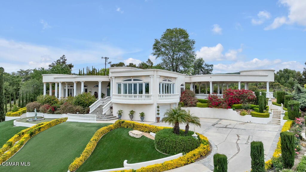 Welcome to this Bellissimo single-story estate in the heart of Conejo Oaks, featuring 4 bedrooms, 5 bathrooms, and 3,468 sq ft of luxurious living space. Nestled on an elevated lot with a sloped driveway, this villa-style home welcomes you through grand custom double doors into an elegant interior with soaring ceilings and a tranquil indoor water feature adjacent to the formal dining area. The chef's kitchen boasts stainless steel appliances, double dishwasher granite countertops with a matching backsplash, custom cabinetry, and designer lighting. Italian porcelain tile floors lead you through arched hallways to spacious bedrooms, all with direct veranda access with stunning views. The primary suite offers a double-sided walk-in closet and a spa-inspired bath with an in-ground soaking tub with water feature. Step outside to a backyard reminiscent of the Roman countryside, complete with a cascading water feature, sunken gardens, outdoor spa, and a massive covered event worthy patio with a fire table, surround sound system, and breathtaking 270-degree views--perfect for entertaining. Chi non va non vede--if you don't go, you won't see--this one-of-a-kind oasis awaits. This home is eligable to have current membership transferred with the Conejo Family Country Club complete with pool, tennis court, basketball court, pickleball, BBQ area, and Children's playground!