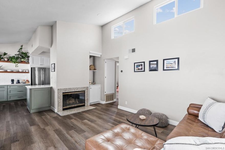 Flooded with natural light, this upper-level unit pairs thoughtful design with everyday comfort. Vaulted ceilings and high windows create an airy, open feel, while the living room fireplace adds warmth and character.   The kitchen was reimagined to include an extended coffee bar and open shelving, blending style and function with stainless steel appliances and clean modern finishes. Both bathrooms have been updated, and new flooring runs throughout, tying the spaces together.  Spacious bedrooms offer peaceful retreats, each with ample storage and soft natural light. Additional comforts include central HVAC, an in-unit stacked washer and dryer, a private one-car garage, and an additional driveway space.  Tucked within a quiet, 7-unit complex, this home sits just steps from University Heights’ local cafés, bars, restaurants, schools and parks. A perfect mix of design, convenience, and walkable city living in one of San Diego’s most beloved neighborhoods.
