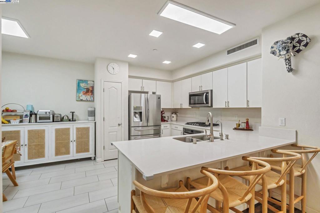 Motivated Seller ! Elegant two-level east-facing home with partial view of the hill in the sought-after Communications Hill community. The open layout features a spacious living room flowing into a gourmet kitchen with Caesarstone countertops, white cabinets, stainless steel appliances, gas cooktop, RO water purifier, and a private dining area leading to the balcony. Master bedroom with dual sinks.One full bedroom and bath on the lower level offer privacy for guests or parents. Upgrades include luxury vinyl plank flooring, fancy recessed lighting throughout, and over $40K in builder finishes for kitchen, bath, and lighting. The finished 2-car garage features epoxy floors, EV charger (NEMA 14-50), tankless water heater, water softener, and custom storage. Enjoy a walkable, family-friendly neighborhood with trails, nearby parks perfect for kids, and the iconic San Jose Grand Staircase just steps away. HOA covers landscaping and trash collection. View 3D tour. Easy access to Hwy 87 & 101. Move-in ready come take a tour and make it yours!