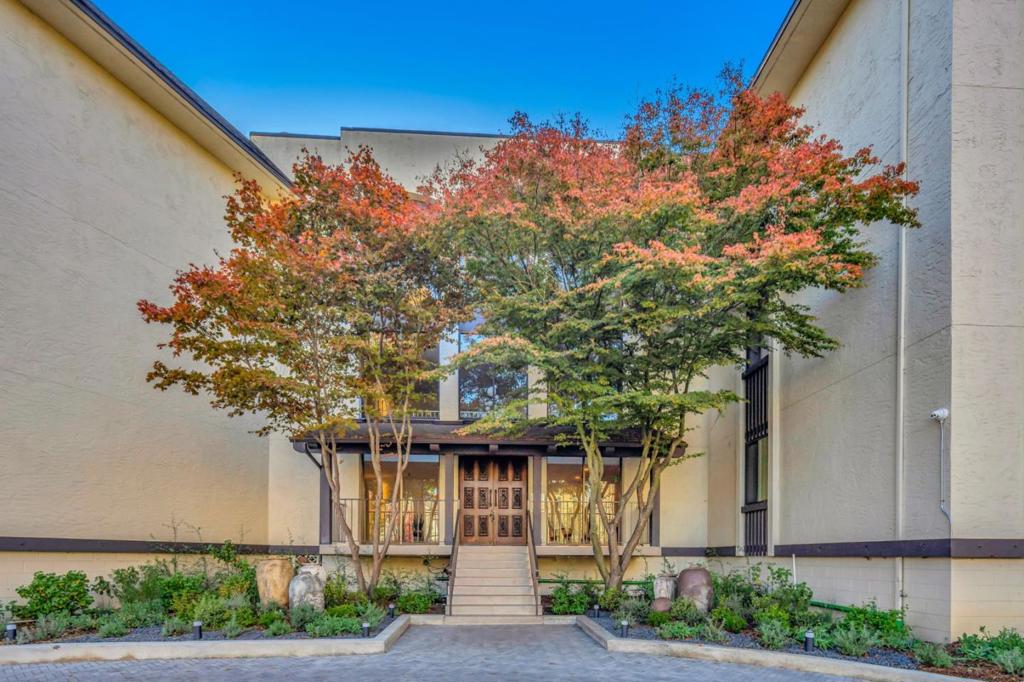 This condominium is a stunning example of modern living, boasting an extensive remodel with stylish designer elements. The new kitchen has granite countertops, a backsplash, and all-new stainless steel appliances. The foyer shines with silk-like vinyl flooring. Both bathrooms are elegantly upgraded with new quartz and porcelain countertops. The spacious living room is notable for its ceiling-to-floor sliding windows that frame the lush outdoor trees, visible from the comfort of your deck. The condo is freshly painted and features lush new carpeting throughout. The expansive primary suite offers ample closet space. For added convenience, the washer and dryer are located just two doors away in the hallway. The condominium complex provides excellent amenities, including two storage units, a workout room, a pool, a BBQ area, and a cabana. Parking with two spaces: one in the garage and another in a secure outdoor area. Only minutes away from Burlingame with fine dining, shopping, and transportation.