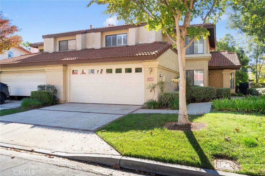 Welcome to 1548 Vallecito Drive, a stunning two-story home in the hills overlooking the Pomona Valley boasting 3 spacious bedrooms (with potential for a fourth via the downstairs office), 3 full bathrooms, central heating and cooling, and 2,243 square feet of elegant living space. This residence exudes charm with contemporary tile flooring, vinyl shutters, and ceiling fans throughout most rooms. The high-ceilinged living room features a cozy tile fireplace and a built-in wet bar, perfect for entertaining, while the family room offers another inviting fireplace for those cozy evenings. The primary suite upstairs indulges with vaulted ceilings,  double sinks, a jacuzzi type tub and separate shower. Outside, a low-maintenance patio provides a serene escape, complemented by a 2-car garage. What elevates this property is its prime location, where outdoor adventures are literally a short walk away. Stroll to Bonelli Park for scenic trails, biking, and tranquil lake views at Puddingstone Reservoir. Indulge in unique dining at Pomona Valley Mining Company, Coco Palms, or downtown La Verne, a beloved local spot ideal for family outings or special occasions. Golfers will adore the easy access to Mountain Meadows Golf Course, and for everyday recreation, Ganesha Park’s trails, sports fields, and picnic areas are just steps from the community, blending nature seamlessly into your routine. Its proximity to Cal Poly Pomona, Mt. San Antonio College, the LA County Fairgrounds, and quick access to the 10, 210, 57, 60 & 71 freeways ensures effortless connectivity. At 1548 Vallecito Drive, you’re investing in more than a house—you’re embracing a lifestyle of comfort, community, and convenience, all while enjoying the perks of a homeowners association for added peace of mind.