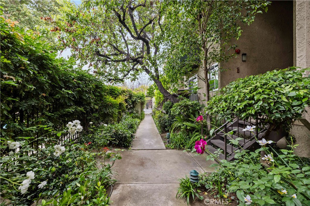 Welcome to this inviting 2-bedroom, 1-bathroom condo offering 859 square feet of comfortable living space in a secure gated community. This upper-level unit features vaulted ceilings and abundant natural light, creating a spacious and airy atmosphere. The open living area flows into a private balcony—perfect for relaxing or enjoying a quiet morning. The kitchen offers ample cabinet space and a breakfast nook for casual dining, making it both functional and welcoming. One bedroom includes a generous walk-in closet, while the second bedroom features its own sink and cabinet space for added convenience. The hallway provides additional storage with ample closet space and built-in cabinets. The full bathroom includes a tub/shower combination. The community offers a swimming pool and spa, guest parking, and a shared garage with a remote-controlled door, individual storage room, and washer/dryer hookups. It is conveniently located near Starbucks, Ralph's Market, and shopping centers, dining, and major commuter routes.