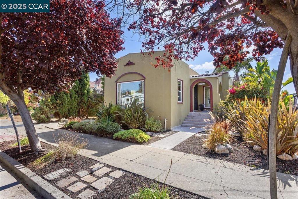 Located in the heart of Oakland’s Maxwell Park, this beautifully preserved Craftsman pairs timeless character w/updates thru-out. Inside, you’ll find 1,257 sq. ft of living space, refinished hardwood floors, woodwork, & an abundance of natural light. The living room feat. an oversized picture window & fireplace—perfect for relaxing. 2 spacious bedrooms; one w/a bright bonus space, ideal for a home office, lounge, or workout area. Step onto the upper deck to relax & take in views of the backyard sanctuary. Updated kitchen feat. wood cabinetry, stone countertops, & tile backsplash, along w/a charming breakfast nook. A utility area just off the kitchen adds extra function & storage. Downstairs, a 400 sq. ft bonus room w/full bathroom & separate entrance offers flex. living options—whether as a en-suite, workspace, or income-generating unit. The backyard is a sanctuary: multiple patios, a grassy lawn & lush, mature landscape —includ. Japanese maples, bamboo & fruit trees—create a private & peaceful retreat. A detached two-car garage w/long gated driveway provides ample parking or potential for future conversion. This is a rare opp. to own a piece of Oakland’s history w/Versatile living spaces & an unforgettable backyard refuge —just minutes from parks, shops & commuter routes!