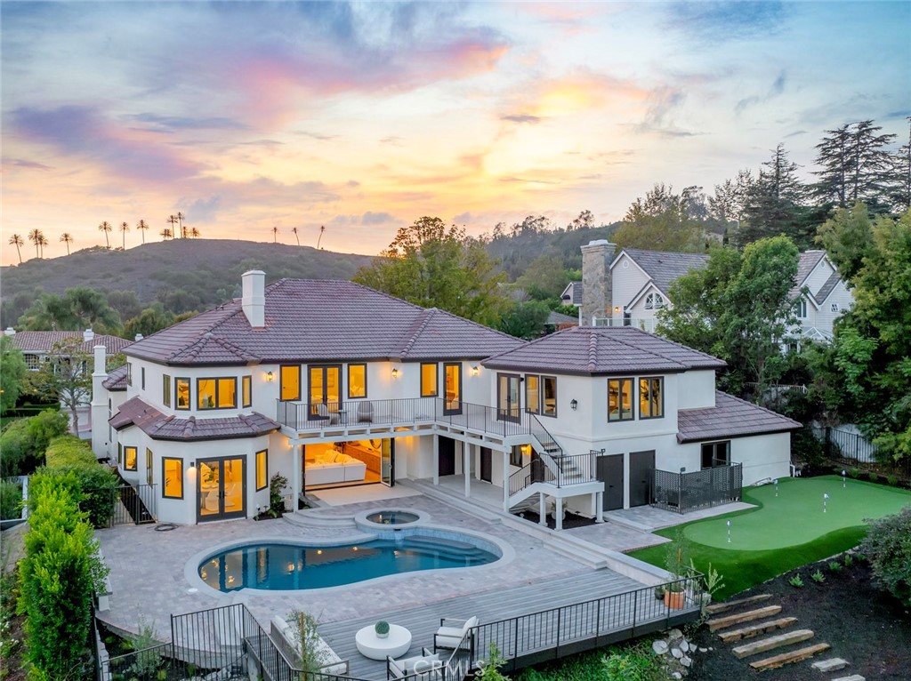 Introducing a world-class estate reimagined from the ground up, where timeless architecture meets modern sophistication. Behind the gates of the prestigious Hunt Club, this 6,583 sq ft sanctuary with nearly an acre lot has been meticulously transformed with all-new finishes, landscaping, hardscaping, and a resort-style pool and spa crafted to deliver the pinnacle of Southern California living. From the moment you enter, soaring ceilings and grand living spaces set the stage for luxury on an extraordinary scale. Every detail reflects bespoke craftsmanship, from the chef’s kitchen with custom cabinetry and professional-grade appliances to the expansive great room and seamless indoor/outdoor flow. Six bedroom suites—including a primary retreat of palatial scale with spa-inspired bath and dressing areas offer both privacy and indulgence. Adding to the estate’s appeal, a private guest house creates the perfect setting for visiting family, extended stays, or a secluded home office, providing ultimate flexibility without compromise. The newly envisioned grounds are nothing short of spectacular: a custom putting green, sparkling pool and spa, and multiple entertaining terraces framed by lush gardens, setting the stage for both intimate gatherings and grand-scale entertaining. Set in one of San Juan Capistrano’s most coveted guard-gated communities, this property embodies prestige, privacy, and lifestyle a true legacy estate for the most discerning buyer.