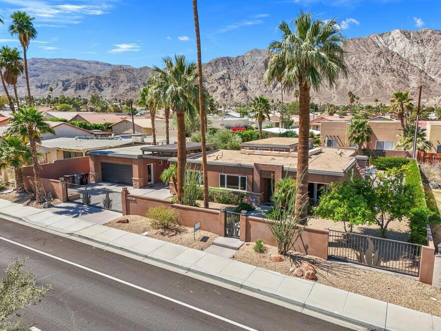 Welcome to your dream retreat in downtown La Quinta! This remarkable **3,064 sq ft** home sits on a **huge double lot**, offering an abundance of space and luxury living. With **five bedrooms** and **four baths**, this home is perfect for families and entertaining guests. A standout feature is the **detached 500 sq ft Casita guesthouse**, complete with a bedroom, full bath, living room, and kitchenette, providing the ideal space for visitors or potential rental income. The property also boasts potential RV access with a gated entry, ensuring convenience for all your recreational needs.Security and privacy are paramount, with a private driveway and garage featuring a security gate with remote access. The main home includes a two-car garage plus an additional golf cart garage, catering to all your parking requirements.Inside, you'll find elegant French doors in each bedroom that open to the enchanting outdoor space, complemented by beautiful travertine flooring throughout. The modern kitchen, designed for both aesthetics and functionality, features updated cabinetry and upgraded stainless steel appliances, making cooking a delight.Step outside to discover a backyard oasis perfect for entertaining and relaxation. Enjoy outdoor fun with bocce ball, a cozy fire pit, a refreshing lap pool, and a spa--all complemented by a built-in barbecue and bar area for alfresco dining.Ideal for outdoor enthusiasts, this home is just a short walk away from hiking and biking trails, as well as the vibrant shops and dining options in downtown La Quinta. Don't miss this opportunity to own a stunning home in a prime location! Schedule your private tour today and experience the perfect blend of luxury and lifestyle!