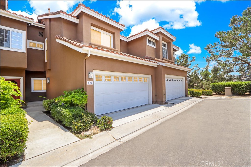 EXCEPTIONAL LOCATION WITH LARGE YARD OVERLOOKING LUSH GREENBELTS AND AWESOME VIEWS, TWO-STORY TOWNHOUSE STYLE FLOOR PLAN WITH 2 BEDROOMS PLUS LARGE LOFT! Highly sought after Provence D'Aliso gated community and desirable location near the end of the cul-de-sac with views of the canyon and the large greenbelt. The floor plan is also highly desirable and features a large foyer, spacious living room with fireplace and high two-story ceilings with large windows to bring in plenty of natural light, large dining room, sliding door leading to the large rear patio with covered area, planters, view of lush greenbelts and plenty of space for your outdoor enjoyment and entertainment. Main floor also features a powder room and direct access to the two-car attached garage. Second story features a true loft with plenty of space for an office, den or can be converted to the 3rd bedroom. Spacious master suite with vaulted ceilings, large master bathroom and a walk-in closet, large second bedroom, full second bathroom and private deck with views of the canyon and city lights! All this plus the highly sought after location within the gated Provence D'Aliso community with resort style pool, spa and tennis courts, easy toll road (73) and beach access, highly sought after schools, excellent proximity to Aliso Viejo Town Center with shops, restaurants and entertainment and direct trail access to Hillview Park and Aliso Creek riding and hiking trail!