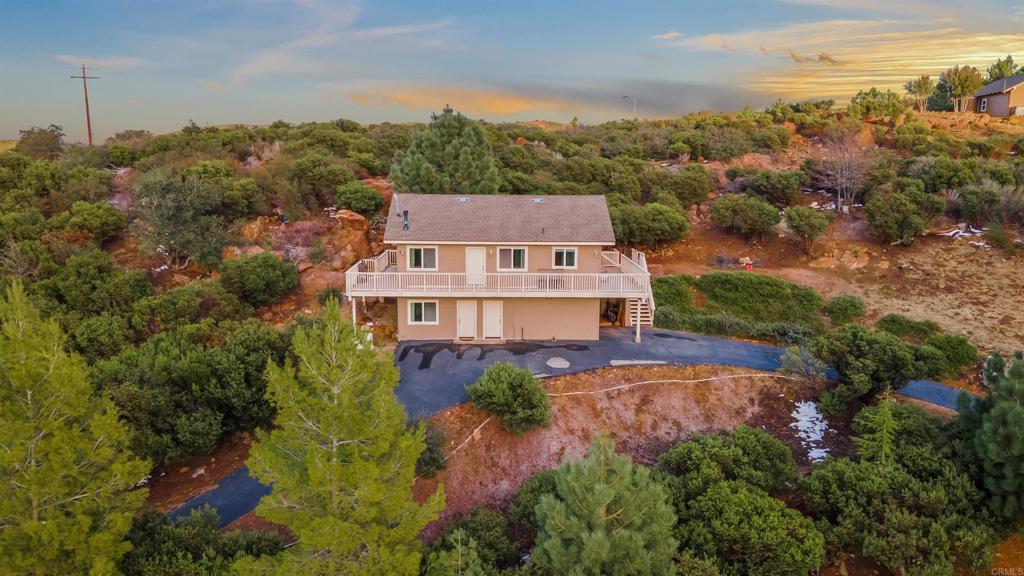 For the View-Lovers & Mountain Dreamers! Perched in scenic Harrison Park, this nearly off-grid 3BR/2BA retreat includes two parcels (2.22 acres total)—the 1.6-acre main lot (35465 Sunset Dr) plus a 0.55-acre bonus lot (35475 Sunset Ln) and Air BNB Popular. With a private well, septic, propane, and SDG&E Generac (add solar for full self-sufficiency), you’ll enjoy true mountain living. Fully furnished & move-in ready, the home features vaulted wood-beam ceilings, quartz kitchen w/ stainless appliances, and a private primary suite. Take in sweeping canyon & sunset views from the wraparound balcony while wildlife roams nearby. Extras: 1-car garage, circular drive (7-car parking). Additional parking at Lot and the Land may have potential for additional small home. Just 10 mins to Julian & Lake Cuyamaca, yet only an hour from San Diego. FHA/VA/Conventional approved. This property is a USDA Approved property, Ask about the 0 down payment with a USDA Loan!