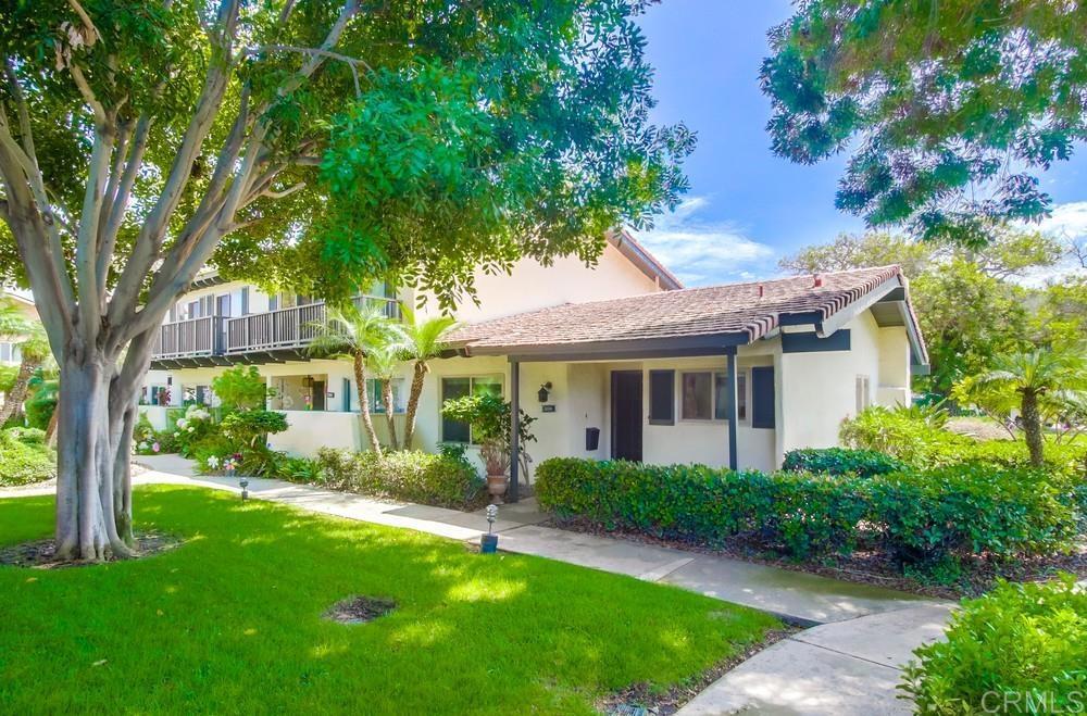Looking for a cute starter home or downsizing? Then consider this super desirable single story condominium that feels like your own slice of paradise! End unit with no one above or below offers lots of privacy. A bonus enclosed sunroom adds nicely to the living space and 2 covered parking spaces makes life simple. Lots of updates inside provides move-in ready comfort and convenience. Granite counters, soft close cabinets and drawers, stainless appliances, laminate wood flooring, dual pane windows, earth tone paint, and much more. The vaulted wood beam ceilings exude a classic style while providing a sense of space and airiness. French doors lead from the 2nd bedroom to the sunroom where you'll also find the laundry room. Everyone loves storage options so you'll be pleased to discover a walk-in closet with organizer in the primary bedroom, closet organizer in the 2nd bedroom, multiple cabinets in the sunroom, and more storage in the carport! Ceiling fans and ocean breezes will keep you cool plus there is lots of greenery in the community. Nearby the swimming pool offers a refreshing dip. Easy access to I-8 and plenty of shopping. A must see!